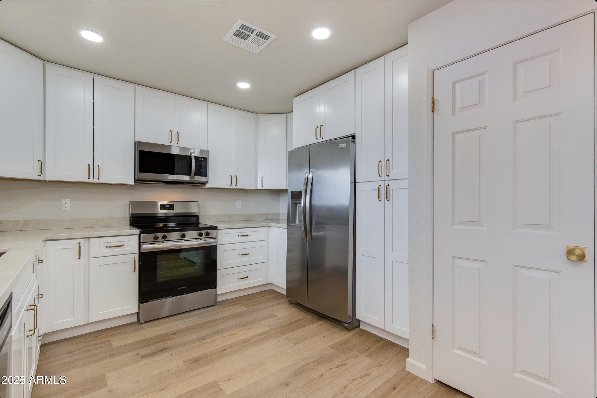 Beautifully remodeled top floor condominium with stunning views of a resort-style clubhouse and pool. Thoughtfully redesigned with today's most desirable finishes, this move-in-ready home features luxurious Taj Mahal quartz countertops, new cabinetry, laminate flooring, fresh interior paint, updated baseboards, designer lighting, modern fixtures, and stylish hardware throughout. The building is equipped with an elevator for easy access, while one of the community's five pools is just steps from your door. The main clubhouse, fitness center, and resort-style amenities are only a short walk away. Enjoy peaceful mornings strolling through the beautiful Cactus Garden or along the pedestrian pathway that borders Stone Creek Golf Course. Your assigned covered parking space is conveniently located directly below the front entrance, and the community recently completed installation of a brand-new, state-of-the-art irrigation system.

Whether you're looking for a full-time residence, seasonal retreat, or lock-and-leave second home, this turnkey condominium offers the perfect blend of modern luxury and resort-style living.