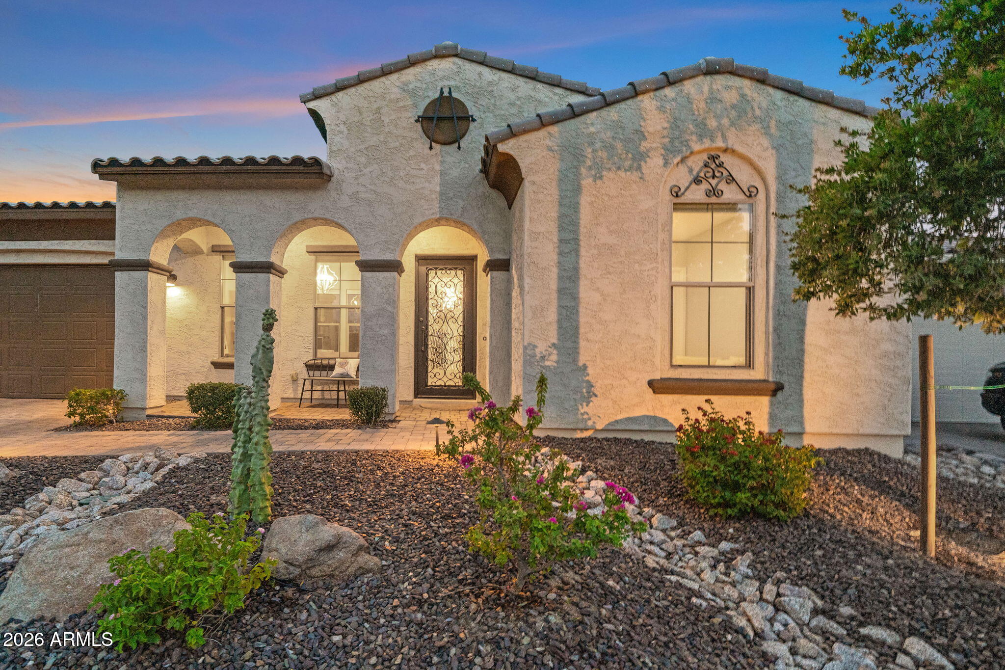 Experience refined desert living in this exceptional residence, gracefully positioned on a premium cul-de-sac lot within the prestigious Venture at Black Mountain community. Designed with timeless elegance and modern sophistication, this impeccably maintained home showcases luxury finishes, thoughtful craftsmanship, and seamless indoor-outdoor living.
From the moment you arrive, the custom wrought iron entry door sets the tone for the exquisite details found throughout. A welcoming private courtyard creates an inviting first impression, while the expansive foyer leads to a spacious den, perfect for a home office, library, or additional flex space. The heart of the home is an impressive gourmet kitchen where beauty meets function. Featuring striking quartz countertops, premium stainless steel appliances, an oversized center island with breakfast seating, custom cabinetry, and an expansive walk-in pantry, this space is designed to inspire everything from intimate dinners to grand entertaining. The adjoining formal dining room provides the perfect setting for memorable gatherings.
The open-concept great room is enhanced by dramatic panoramic sliding glass doors that effortlessly blend indoor and outdoor living, filling the home with abundant natural light while creating an ideal space for entertaining. Designer lighting, wood-look tile flooring, integrated surround sound inside and out, a central vacuum system, and numerous builder upgrades further elevate the home's sophisticated appeal.
Escape to the luxurious owner's retreat, thoughtfully designed as a private sanctuary. The spa-inspired ensuite offers dual vanities, a deep soaking tub, an oversized rain shower, and an extraordinary custom walk-in closet with premium built-in shelving and organization.
Step outside to your own resort-inspired backyard where every detail has been carefully curated. Relax beneath the expansive covered patio, entertain under the custom ramada, or enjoy the beautifully designed paver patio and lush artificial turf--all enhanced by outdoor surround sound and TV connections, creating the perfect Arizona lifestyle.
Additional premium features include a spacious three-car tandem garage with the capability for a 50-amp connection, owned solar panels for enhanced energy efficiency, a well-appointed laundry room with utility sink, generous storage, and exceptional attention to detail throughout.
Perfectly situated just moments from scenic hiking trails, championship golf, upscale dining, boutique shopping, and the vibrant charm of Cave Creek, this remarkable home also offers the everyday convenience of Starbucks just a short walk away. Luxury, comfort, and location come together to create a residence that is as impressive as it is inviting.
