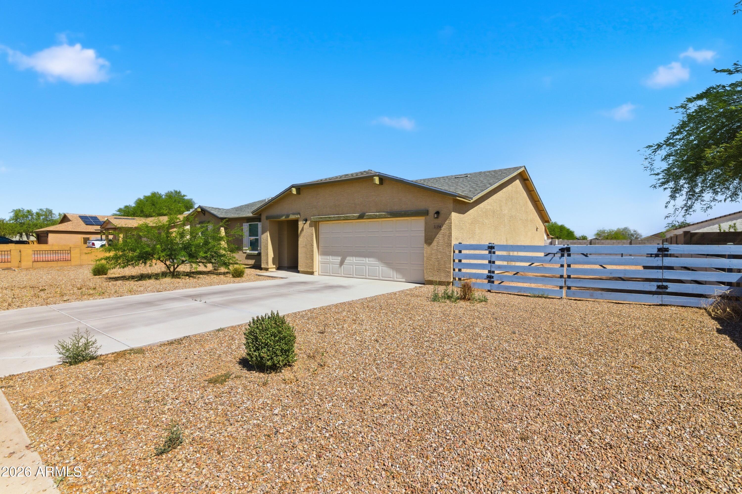 Welcome home to this beautifully designed single-story home built in 2024 in the growing Arizona City community! The desirable Catalina floor plan offers 3 bedrooms, 2 bathrooms, and an open-concept layout perfect for everyday living and entertaining. The spacious kitchen features granite countertops, stylish cabinetry, stainless steel appliances, and an eat-in dining area overlooking the bright living space.

The private primary suite includes dual vanities, a walk-in closet, and a full bathroom with newer upgraded tile and shower finishes for a modern touch -- and all bedrooms feature walk-in closets, providing plenty of storage throughout the home. Newer tile flooring flows throughout the home, creating a clean, cohesive look with easy maintenance.

Situated on an oversized lot with a fenced backyard and RV gate, this property offers the perfect blend of space, privacy, and functionality -- with NO HOA! Enjoy a rural lifestyle feel while still being conveniently close to I-10, shopping, dining, and everyday essentials. Recently built in 2024, this home offers the peace of mind of a newer roof, AC system, water heater, and modern energy-efficient construction. Additional features include dual-pane windows, desert landscaping, and a 2-car garage. A rare opportunity to enjoy newer construction with room for all your toys, pets, and outdoor living dreams!