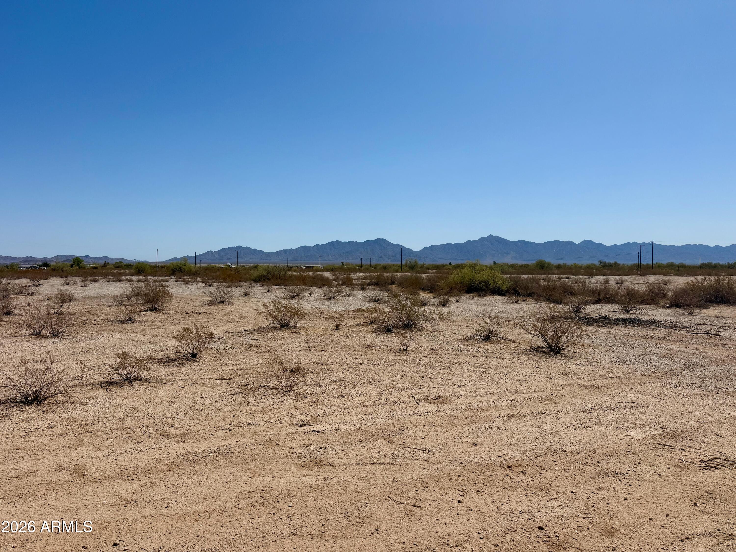 Over an acre of flat, usable desert land with sweeping mountain views in every direction -- the kind of parcel that doesn't sit on the market long. Electric is already at the property, cutting out one of the biggest headaches in land development and putting you that much closer to breaking ground. No grading fight, no awkward slope to engineer around -- just a clean, level canvas ready for your custom build.
Rainbow Valley offers space and privacy without sacrificing accessibility, giving you room to build the home you actually want instead of the one a subdivision allows. Whether you're planning to build now or holding for the right timing, this is a rare combination of usable acreage, utility access, and view potential at this price point.