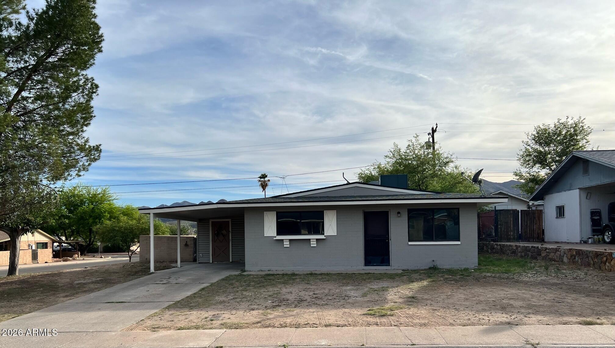 Nice corner lot home! This four bedroom two bath home located in the peaceful town of Kearny, AZ is priced to sell. Many updates including new master shower, new guest bath surround, done all in ceramic tile and installed with new shower valves and plumbing, freshly laid ceramic tile throughout the home. Fresh paint inside and out. Large living room perfect for spending the evenings with your family. Attached covered carport with a storage shed. Back covered patio with privacy wall makes for the perfect spot to host BBQ's with family and friends. House is kept at the perfect temperature with a central AC/Gas package unit. Roof and AC are both approximately 7 years old. This house sits on a corner lot within walking distance to the local park. At this price, this one will not last long