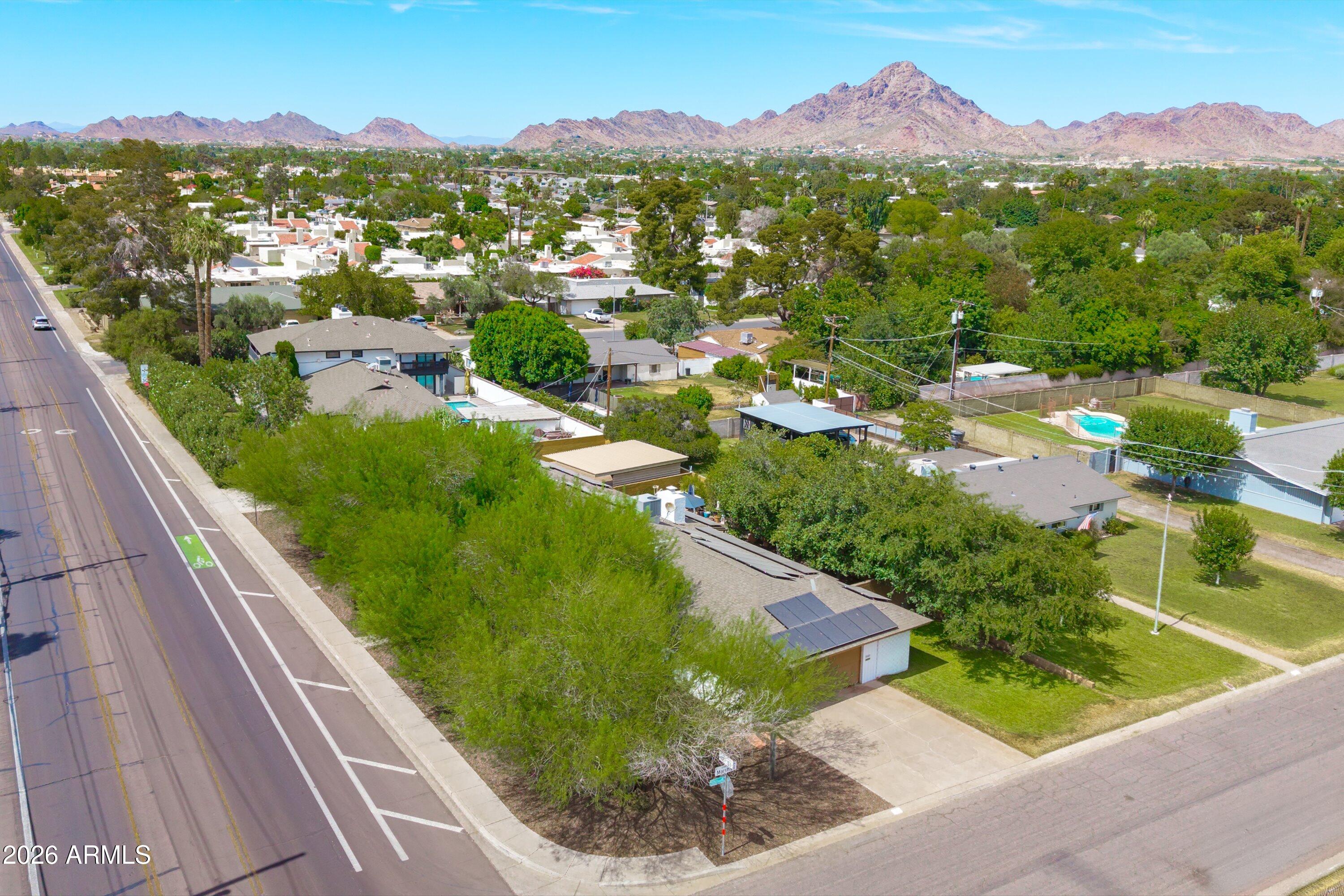 Historic 1954 Del Webb ranch-style home in the heart of Phoenix on a premium 1/3-acre corner lot with mature shade trees. This 2,350 sq. ft. home features owned solar with backup battery, RV gate, 2-car side-entry garage, 3-car covered parking, wood flooring, neutral finishes, and a living area with a fireplace. The galley kitchen offers solid-surface counters, mosaic tile backsplash, built-in appliances, recessed lighting, and ample cabinetry. The primary suite includes a sitting area, outdoor access, and an ensuite bath, while guest quarters offer a separate entry and private bath. Enjoy a covered patio, extended paver seating area, and hot tub in the spacious backyard. See the Documents tab for the history of this unique property.