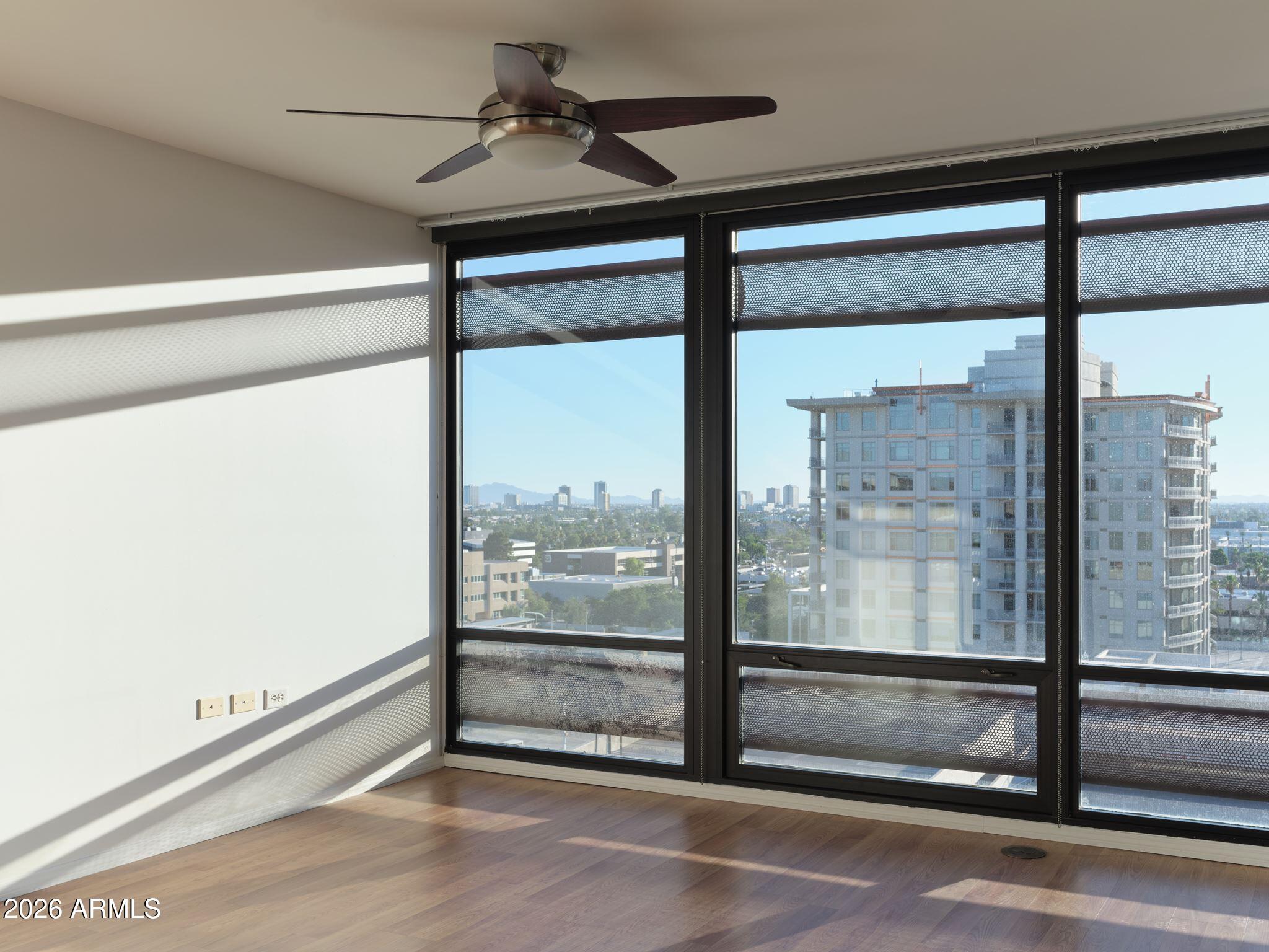Perched on the 11th floor of Optima Biltmore, this 2-bedroom, 2-bath residence offers 1,361 square feet with sweeping city views and sunsets that become part of your daily routine. The private patio feels like a natural extension of the home, creating a quiet place to start the morning or unwind as the Phoenix skyline shifts from day to night. Inside, the spacious primary suite features two closets, while the thoughtful floorpan balances comfort with everyday functionality. The home also includes two secured garage parking spaces and a private storage unit to add everyday convenience.

Life at Optima extends well beyond your front door. Residents enjoy a recently completed multimillion rooftop pool and spa renovation, creating one of the community's signature gathering spaces. Framed by panoramic viewsof the Phoenix skyline and surrounding mountains, the perfect backdrop to relax or entertain above the city. The complex also features a grilling area, fitness center, concierge service, 24/7 front desk support and security monitoring.  

Part of what makes Optima Biltmore so desirable is its accessibility to Biltmore Fashion Park for shopping, restaurants and coffee shops, or Town & Country for everyday essentials like Whole Foods and Trader Joe's. When you're in the mood for one of Phoenix's most iconic meals, Pizzeria Bianco, Tratto and the Gladly are only minutes away. Beyond the neighborhood, Camelback, Piestewa Peak and the Phoenix Mountain Preserve are all just minutes away, while Downtown Phoenix, Arcadia, Scottsdale and Sky Harbor International Airport are all within easy reach. 

Whether you're looking for a lock-and-leave residence or a full-time home, this is a place that makes it easy to enjoy the very best of Phoenix.