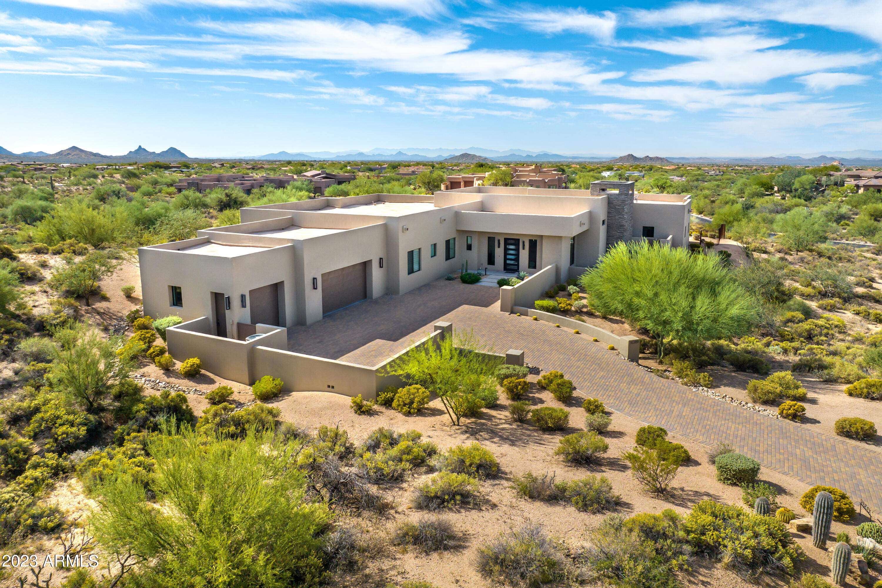 This immaculate newer construction home sits on a small cul-de-sac and is surrounded by incredible Mountain and City Light views!  With 4,576 sq/ft of modern opulence, this single level home with no interior steps offers luxurious high-end finishes and features throughout, satisfying even the most discerning buyer. The amazing split floor plan offers 2 master suites, one additional bedroom with an en-suite bathroom and 2 additional bedrooms.  The great room has a linear fireplace & 4- panel stacking slider opening to a large patio, creating the indoor/outdoor lifestyle Arizona is famous for. The chef's kitchen has quartz countertops and backsplash, bar seating, 6-burner gas cooktop and more. The home is Energy Star Certified, and the exterior was painted, and the roof resurfaced in 2022. The backyard oasis has a heated pool and spa, built-in BBQ, and multiple seating areas for friends and family to gather.  The home backs to a vacant lot that is owned by the seller that is not included in the price of the home but could be purchased separately.