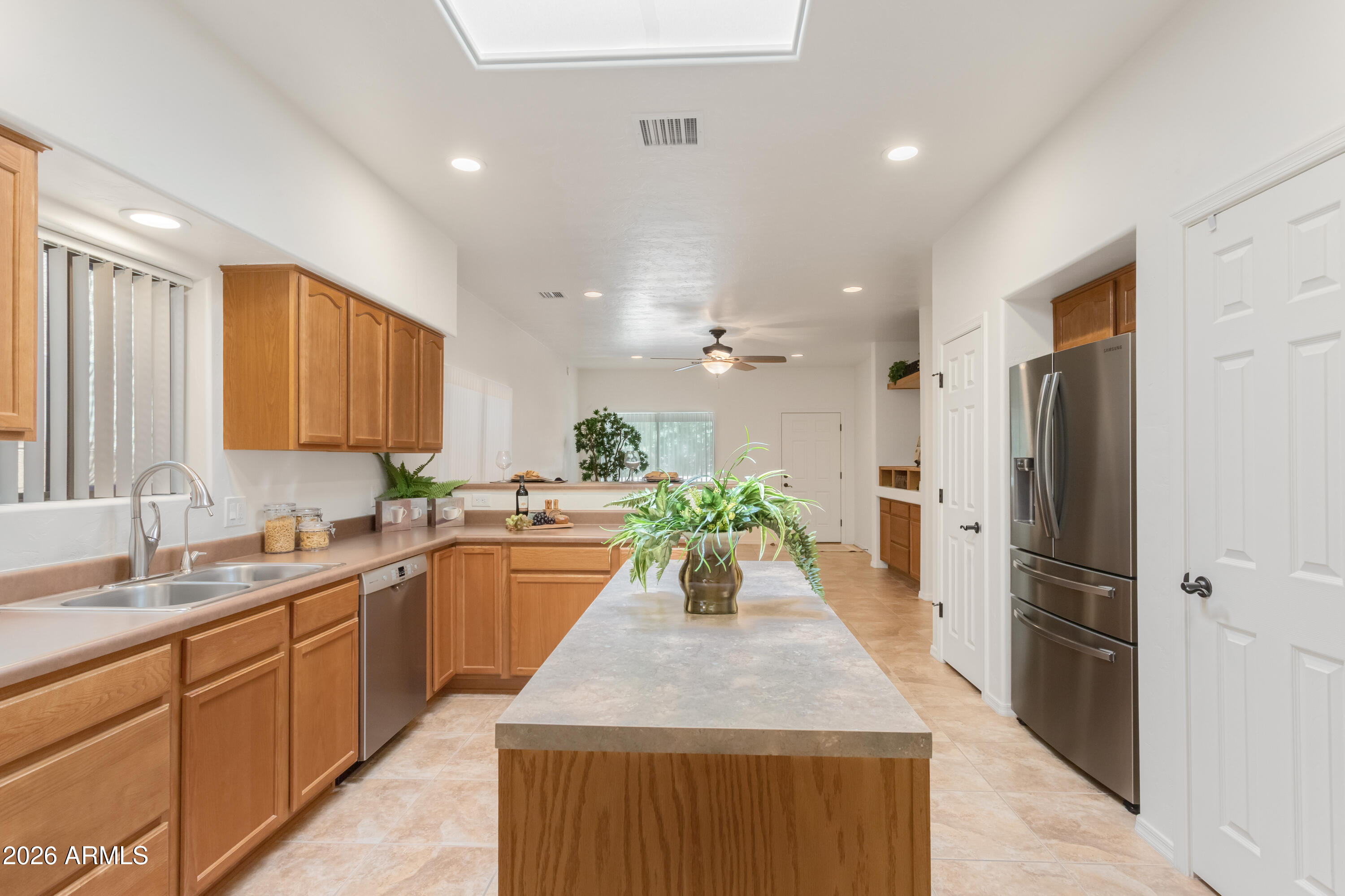 Beautiful 3BR/2BA Dakota Model in the desirable 55+ Vista View Resort! This well-maintained home features many upgrades such as Tile and Laminate flooring,  Beautiful SS Appliances, kitchen island, built-in entertainment center, custom security door, ceiling fans, upgraded window shades. The garage has a utility tub, built-in storage and owned water softer. The spacious primary suite offers double sinks and a large walk-in closet. Enjoy the large front courtyard and private backyard with a beautiful privacy wall and extended Flagstone patio. This is resort-style living at it's best. The Resort fee includes property taxes and trash, clubhouse, year-round heated pool and spa, fitness center, pickleball, dog parks, EV charging stations, clubs, painting classes, potlucks and much more.