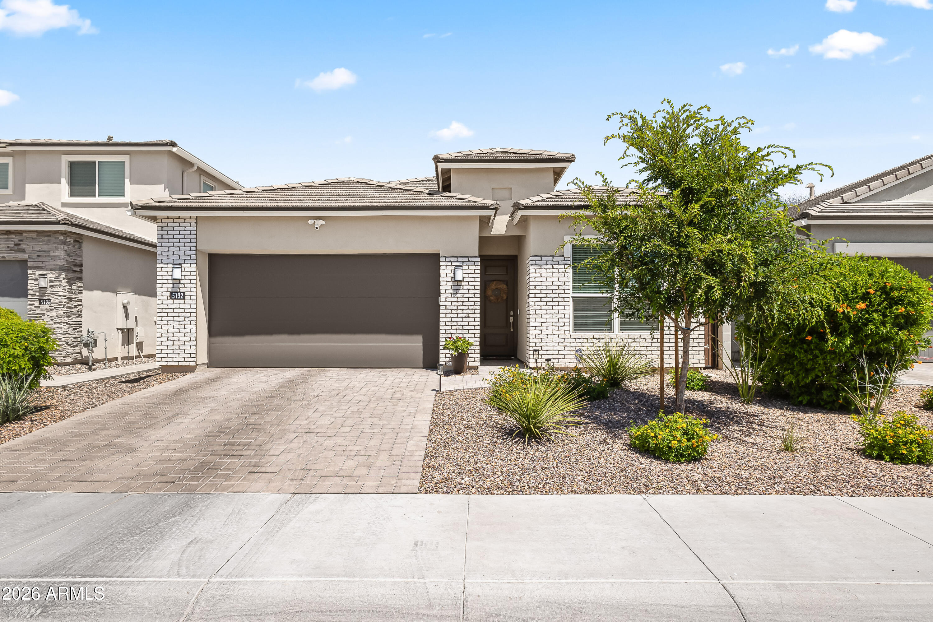 Like-new and lightly lived in, this 2023-built single-level home is move-in ready in the gated community of Arabella. With 4 bedrooms, an office/den, and 3 full bathrooms, the open-concept layout feels effortless and elevated from the moment you walk in. The kitchen is a standout with quartz countertops, sleek white cabinetry, full tile backsplash, and under-cabinet lighting, all flowing seamlessly into the great room. A 12-foot sliding glass door floods the space with natural light and opens to an extended paver patio--perfect for that indoor-outdoor Arizona lifestyle. Out back, you'll find low-maintenance turf and a spacious patio designed for relaxing or entertaining. Smart home features and surround sound pre wired add to the modern feel. Located in Arabella with gated entry, resort style pools, and a large central park, all just minutes from the 51 and 101, plus some of the best shopping and dining in the area.