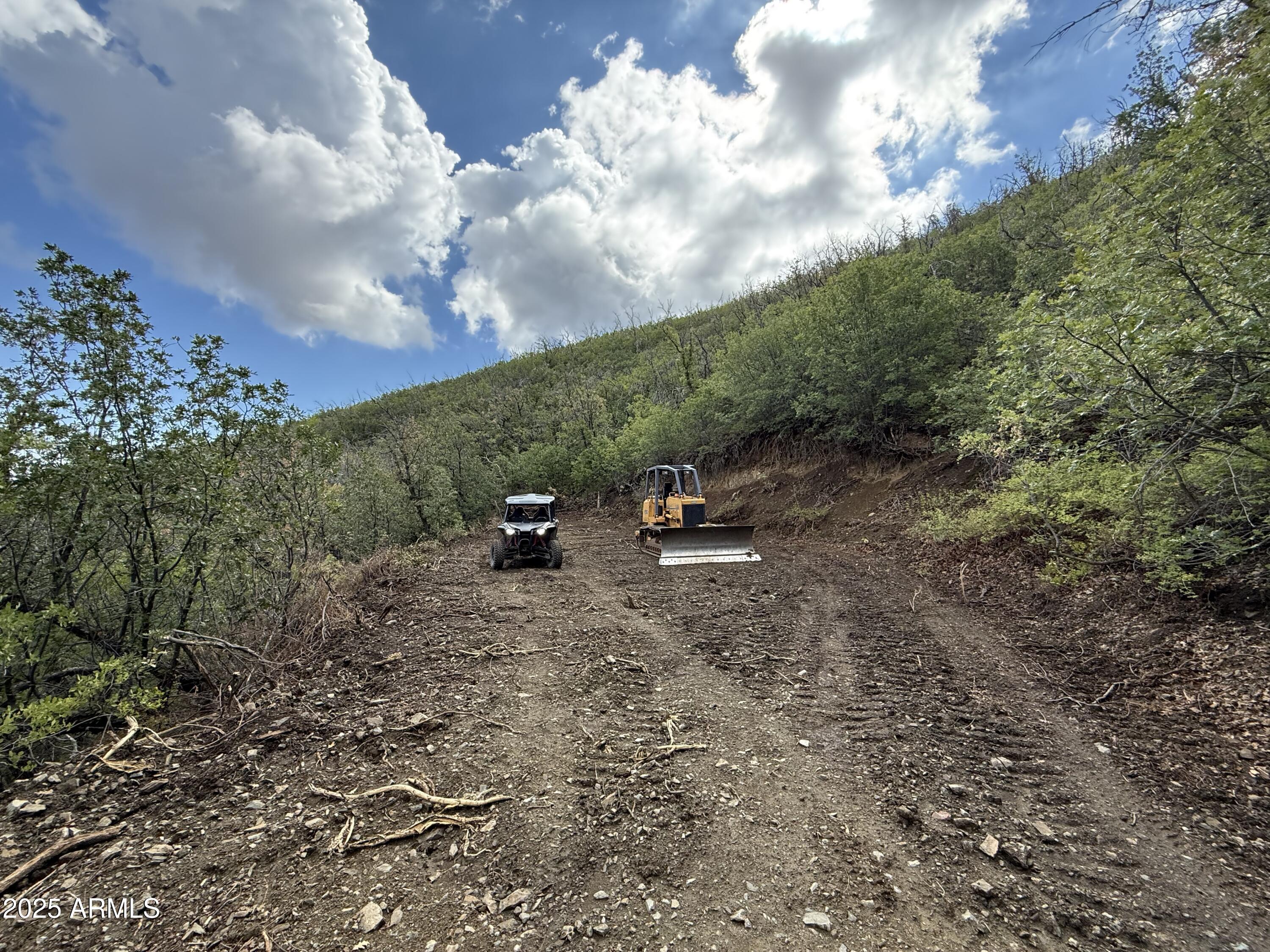 Build your very own custom off-grid cabin on this beautiful hillside 2 acre parcel. This land is complete with driveway and large building pad. Lot features an incredible expansive views and borders Prescott National Forest. 100% of mining rights do convey. Escape the valley heat and enjoy all four gentle seasons Crown King has to offer. 1,200 square foot minimum build requirements. Only 1.5 hours from North Phoenix yet far from ordinary. Hillside acreage offers some of the best views in Crown King. Enjoy the distant city lights of Cordes Lakes on the desert floor below. At over 7,000 ft elevation, you can expect chilly nights and lots of snow in the winter.
