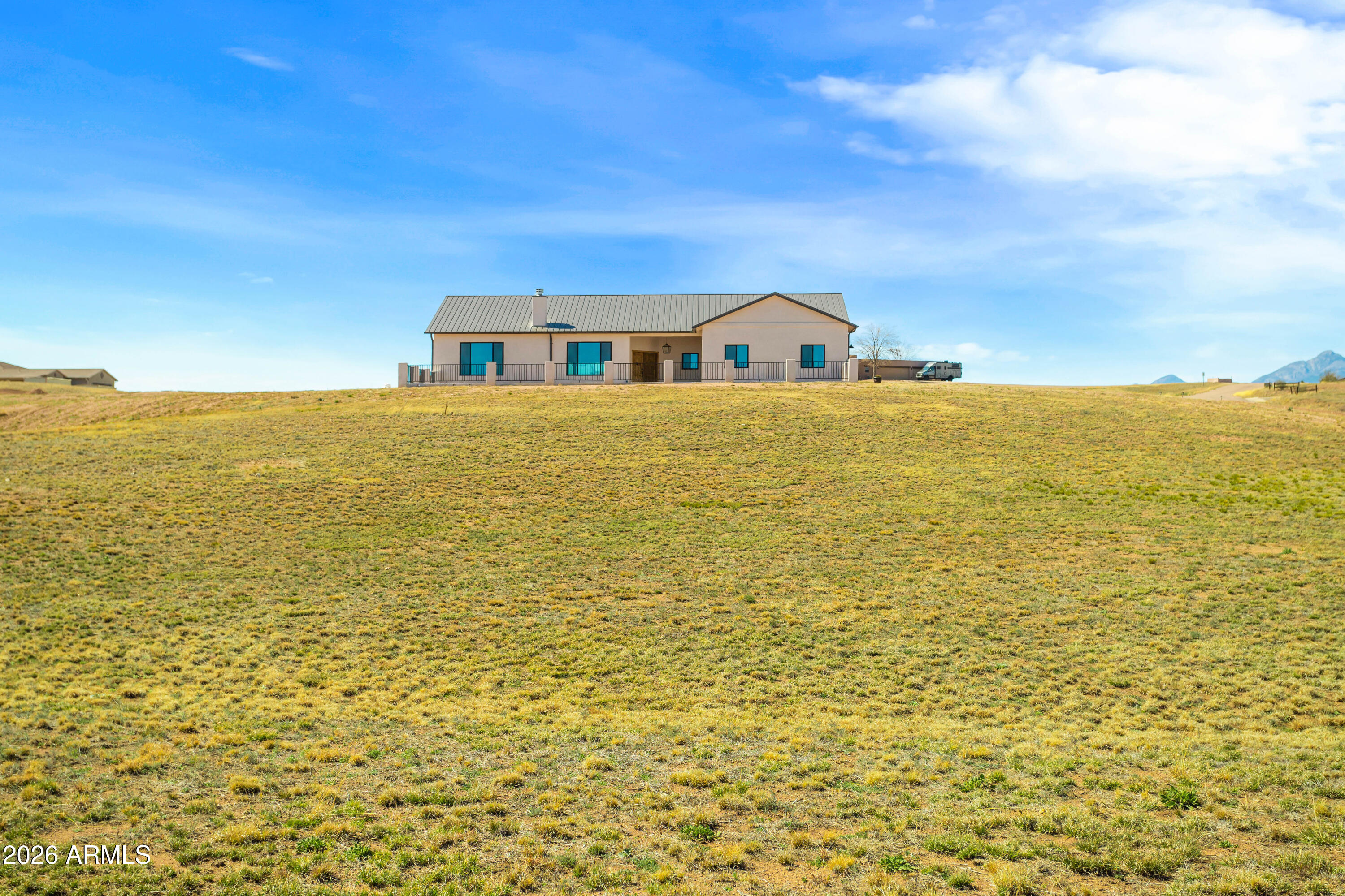 Attention to detail makes this Beautifull Custom-built 2000+sq. ft. home a must have. On a premium high knoll 4.13-acre lot enjoy amazing views of the Mustang and Santa Rita Mt. ranges. Star lite night skies from all directions. Inviting front courtyard with covered entry.  Wood tile floors throughout. Large great room, Living area complete with corner wood/gas fireplace. Kitchen perfectly done w/ high-end finishes. Alderwood cabinets, black stainless steel appliances Quart's counter tops island/breakfast bar. Double door pantry cabinet. Primary suit with large picture window allowing for natural sun light. Onset bathroom, his and her vanity tile surround shower. 2 additional guest rooms. Located in the Santa Cruz Wine country. Where the Deer and antelope roam. no HOA