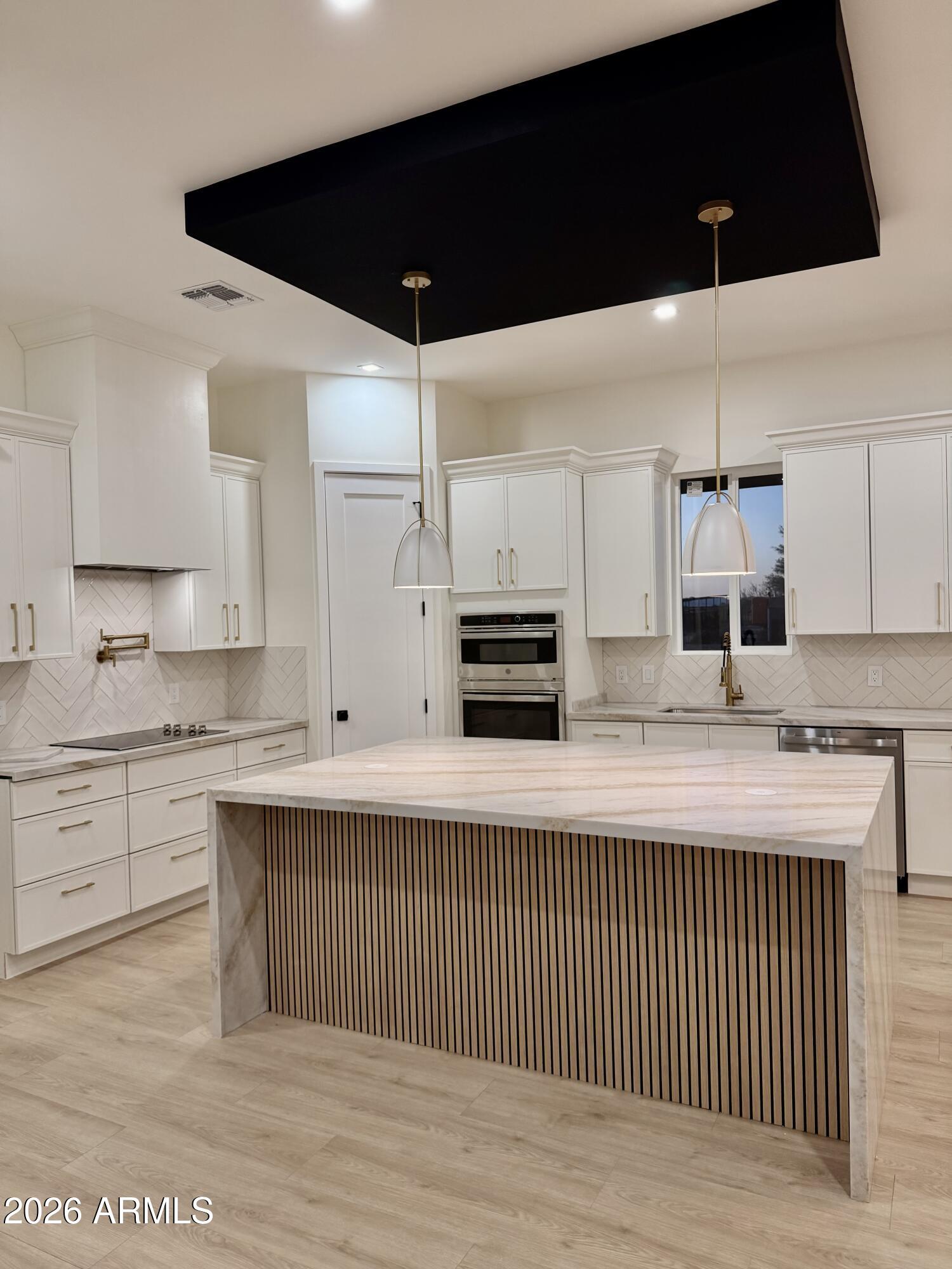 2026 site-built home on 1.11 acres. No HOA. Less than 1 mile to Arlington Elementary. 4 bed/2.5bath, split floor plan, 10-ft ceilings, 8-ft doors, 2x6 framing & spray foam insulation. Iron front door, wired security cameras & upgraded finishes throughout. Designer kitchen: custom 42'' cabinets, drawer-heavy lowers, Taj Mahal countertops, 5x7 island, built-in micro/oven combo & stainless appliances. Primary suite w/ freestanding tub & separate walk-in closet. Generously sized secondary bedrooms and closets. Oversized 30x24 3-car garage w/ 240V/50-amp EV outlet. Licensed builder w/ full warranty. Private water & septic.