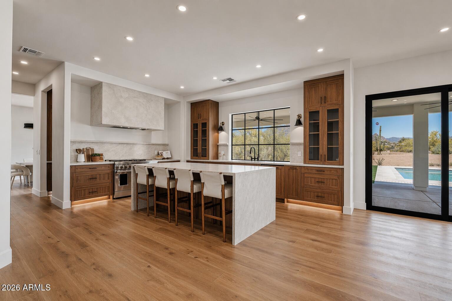 Completely reimagined Cave Creek estate on 1.15 acres, where mountain views, open desert, and privacy define the setting. A dramatic great room with soaring 20-foot ceilings and natural light flows into an expansive kitchen with custom cabinetry, Taj Mahal quartz, and a 48-inch range. A 15-foot collapsible slider opens to a newly built backyard with pool, firepit, and private pickleball court. Upstairs, the primary suite offers a quiet retreat with views. The detached 2,500 sq ft RV garage delivers exceptional scale for collectors, storage, or future use, complemented by a 4-car garage. No HOA and pre-paid solar lease complete the offering.