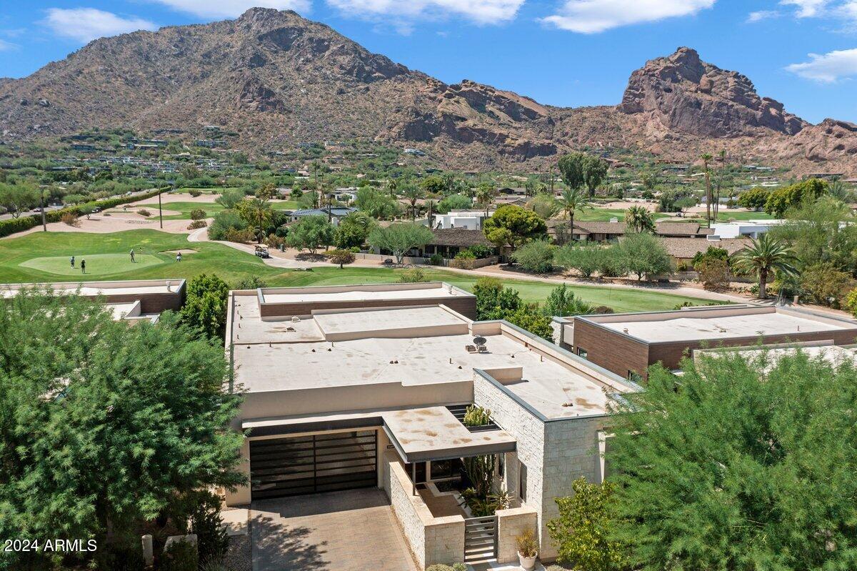 Beautiful Paradise Valley Home! Nestled in the prestigious Mountain Shadow Resort, this luxury home offers breathtaking views of Camelback Mountain and the golf course. Designed for seamless indoor-outdoor living. the residence features soaring 12ft. ceilings and expansive 9ft. bi-fold doors that open to a serene patio and English garden. The gourment kitchen is a chef's dream, equipped with top-of-the-line Wolf appliances including oven, microwave, and steamer over, along with a Sub-Zero refrigerator and wine storage. The home boasts four bedrooms, with a luxurious primary suite that provides stunning views of Camelback Mountain. The state-of-the-art Savant system allows for remote control of lights, TV, shades and security, ensuring convenience and peace of mind. The property is secured with a 24-hour guarded-gate entry, offering both privacy and security.