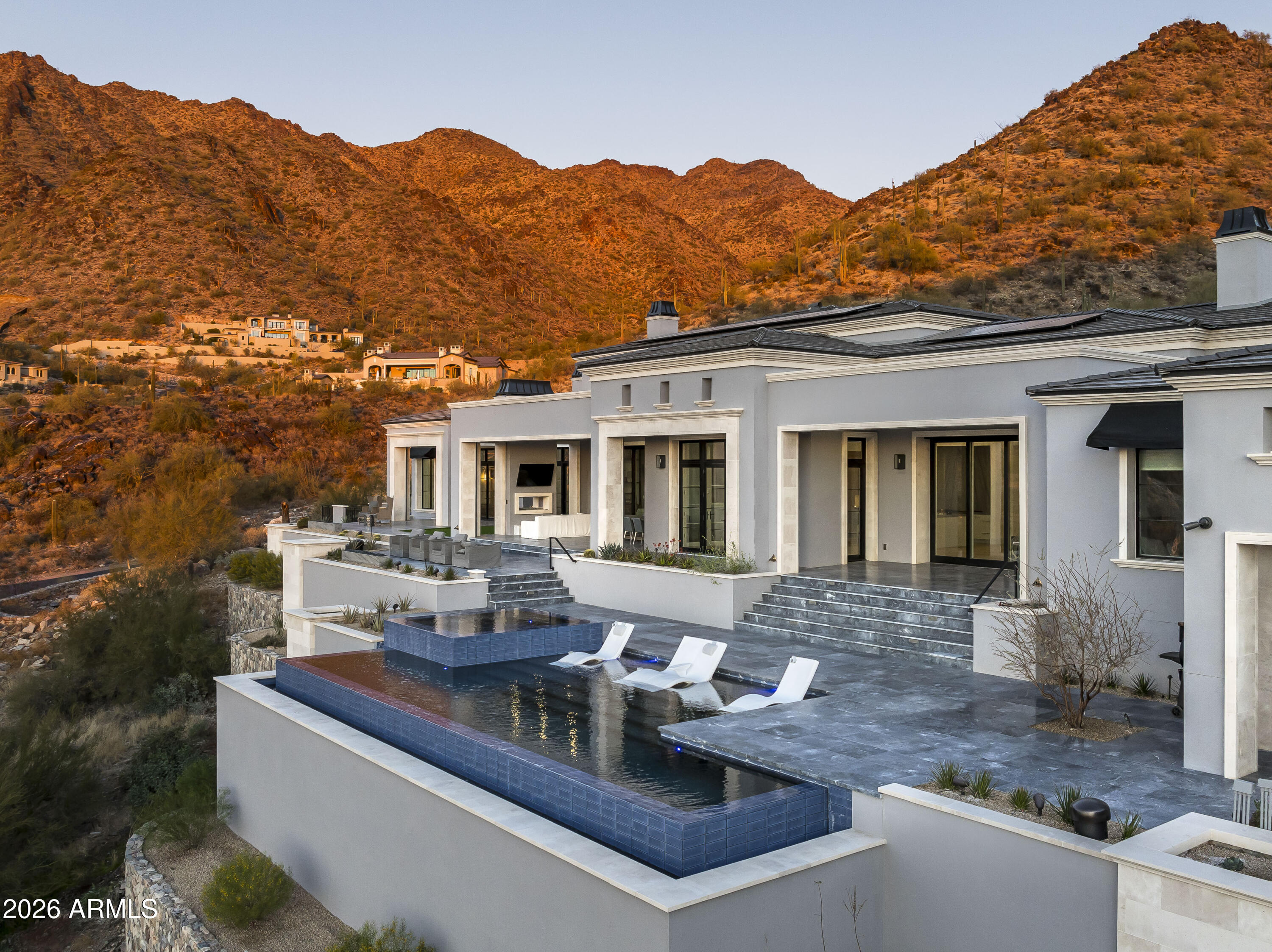 Surround yourself with the highest level of luxury in this recently completed home in the Summit at Silverleaf. A Modern Formal Mediterranean estate with the highest quality features and finishes including; 7 foot tall book matched quartzite kitchen backsplash, soaring 21 foot ceilings in the kitchen, great room, dining room and office. The 4 car garage has 12 ft ceilings, ready to install lifts to double the capacity. The back yard beckons with an infinity pool, raised hot tub, see through fireplace, putting green and amazing gas fire features. Enjoy all of this with unparalleled views of the McDowell Mountains and city lights. This sanctuary includes sustainable features such as solar panels, spray foam insulation and high efficiency windows/doors as well as the lates Control4 smart home automation. Silverleaf, located in North Scottsdale, Arizona, is a prestigious guard gated community known for its luxurious estates, exclusive golf courses, private Club and stunning desert landscapes. 

 

The Tom Weiskopf-designed Silverleaf Golf Course is a highlight for golf enthusiasts. With a blend of Spanish and Mediterranean-inspired architecture, the community offers a high standard of living, including upscale amenities like spas, fine dining, and exclusive shopping. Residents enjoy a harmonious balance between modern luxury and the natural beauty of the desert environment, making Silverleaf a sought-after destination for those seeking an exceptional lifestyle in North Scottsdale. Silverleaf, located in North Scottsdale, Arizona, is a prestigious guard gated community known for its luxurious estates, exclusive golf courses, private Club and stunning desert landscapes.