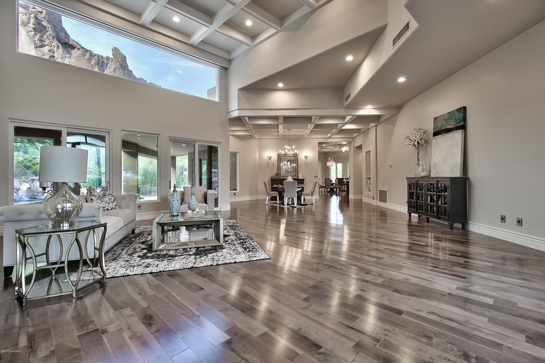 Stone Canyon! Exquisite 2015 total remodel nestled at the base of Camelback Mountain with astounding views. This 5 bedroom 5 1/2 bath masterpiece has been recreated and designed using a transitional theme, the highest caliber materials and a soft yet current color palette. From the moment you enter, the 20ft ceilings and a wall of glass framing the sheer rock cliffs will amaze. The expansive living and dining room flows effortlessly into the kitchen and family room. The master suite is an elegant and private retreat with nearby library / den while 3 separate bedroom and bathroom suites occupy the other side of the house. The guesthouse is of the same caliber as the main home and has its own kitchen and separate bedroom. The enormous 1300sf garage could easily house 6 vehicles Deep covered patios  provide ample shade and open to the lagoon style negative edge pool with grotto , slide and waterfall. The home is effectively all new from the AC systems, tankless water heaters, hardwood flooring, beamed/boxed ceilings, marble counters and custom glazed cabinetry, exquisite light fixtures, LED lighting , Sub Zero and wolf appliances including wine locker, beverage drawers and  ice maker.   No expense has been spared on this exquisite home. A complete remodel in  2014/2015  has transformed this 1998 built home into a residence offering a new home experience.