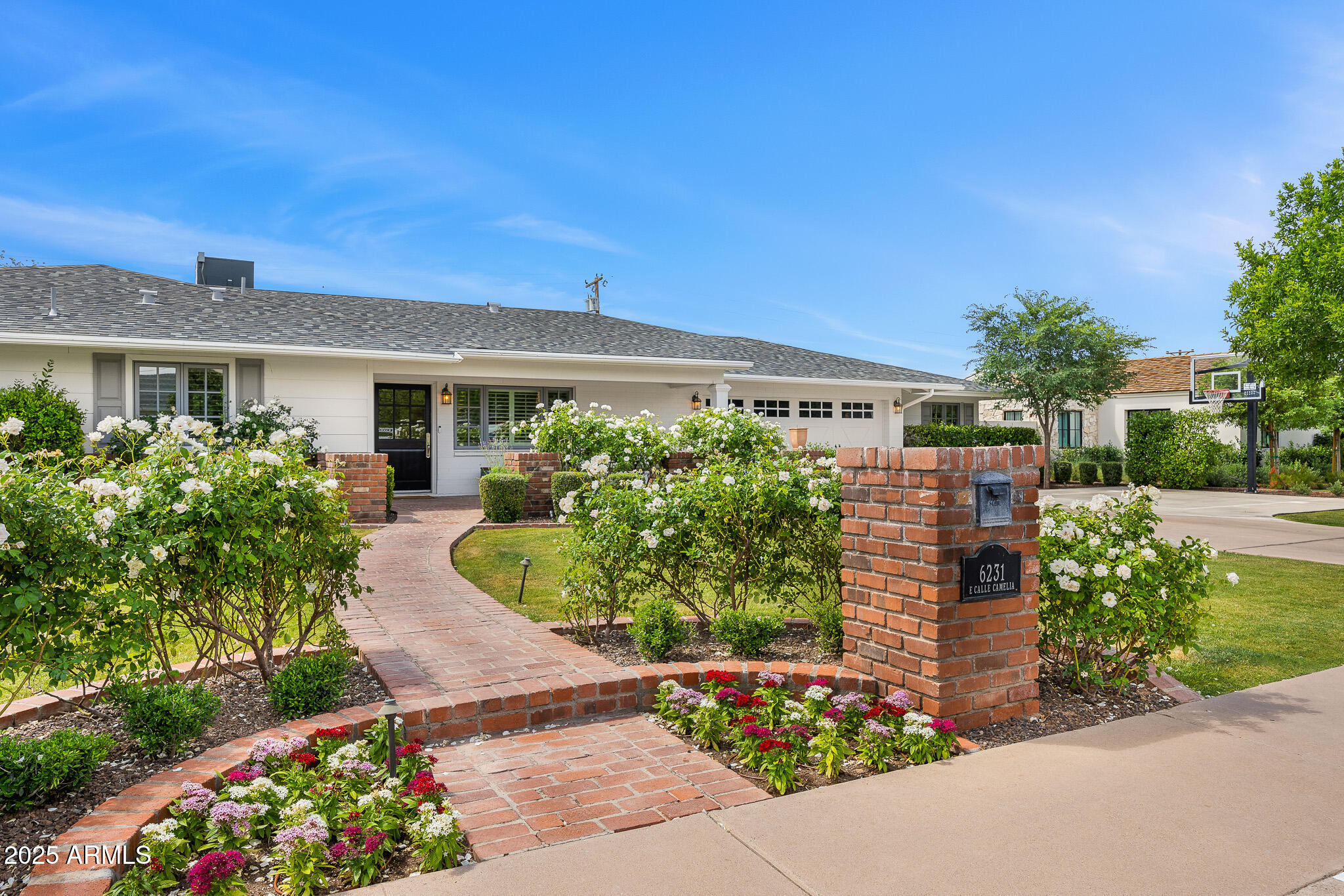 Welcome to your dream home in Arcadia! This beautifully updated 4-bedroom, 3.5-bathroom residence offers 3,317 square feet of thoughtfully designed living space. The open-concept layout features a split floorplan with elegant wood floors, making it perfect for both entertaining and everyday comfort. The gourmet kitchen, complete with crisp white cabinetry and a spacious island, flows seamlessly into the family room and backyard, creating an ideal space for culinary creativity and family gatherings. Step outside to your front porch and enjoy stunning views of Camelback Mountain. The private backyard is an oasis, featuring a sparkling pool, an extended patio, and plenty of room for outdoor dining and lounging. This Arcadia gem is the perfect place for your next home!
