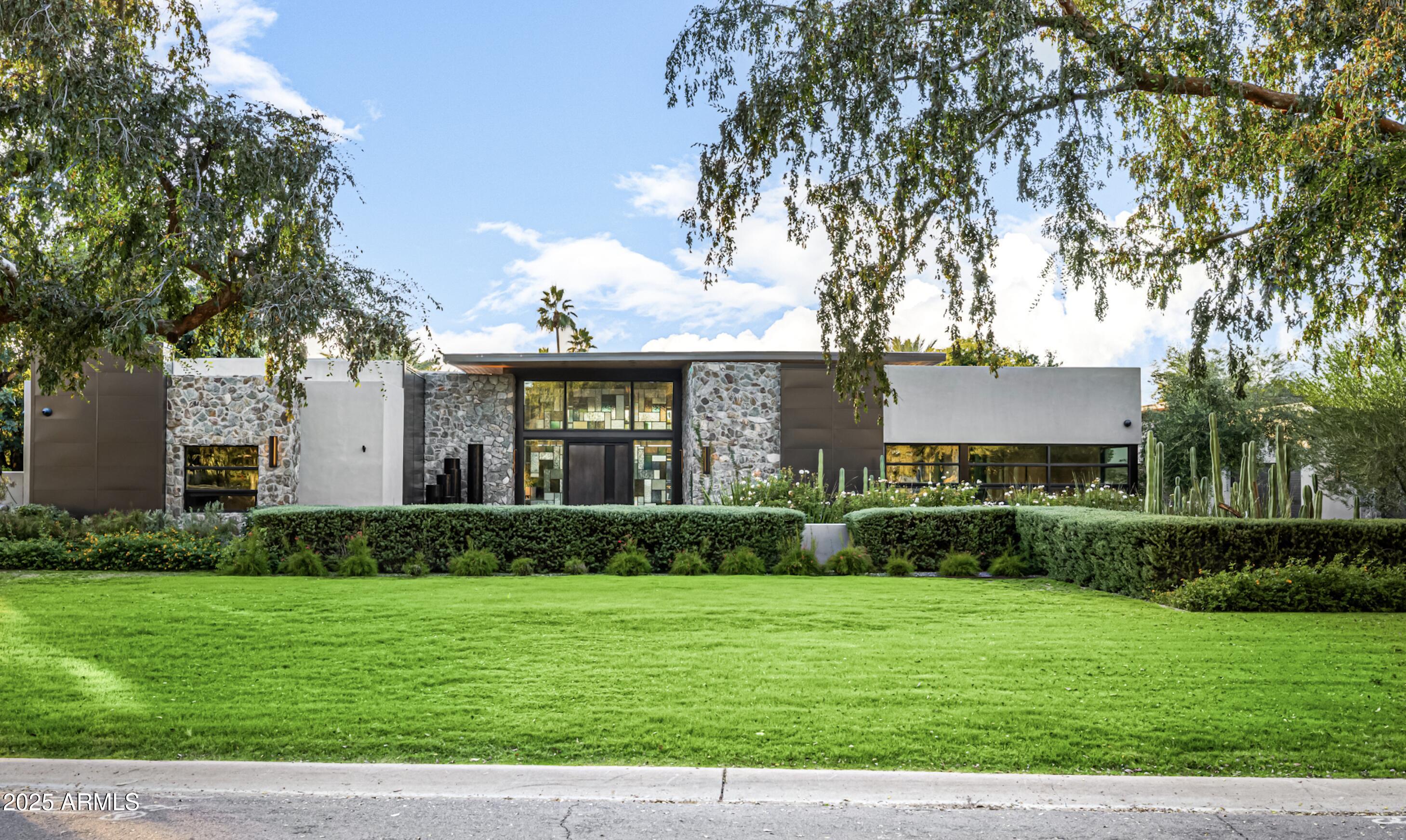 A true Scottsdale estate so rare it feels once-in-a-generation. An acre+ sanctuary in a coveted neighborhood where homes rarely come to market. This 2022 reimagined retreat blends Restoration Hardware elegance with Arizona soul. Soaring 15' ceilings, luxe designer finishes, a cinematic primary suite, and a private casita create a living experience that feels both modern and timeless. Lutron Smart Home System ease throughout. Car collectors: 3,000+ sq ft garage/workshop, 6 bays, 2 lifts, storage for up to 10 cars, plus gated motorcourt. Resort-style pool with waterfall spa. Equestrian stalls and rear corral complete this elevated lifestyle.