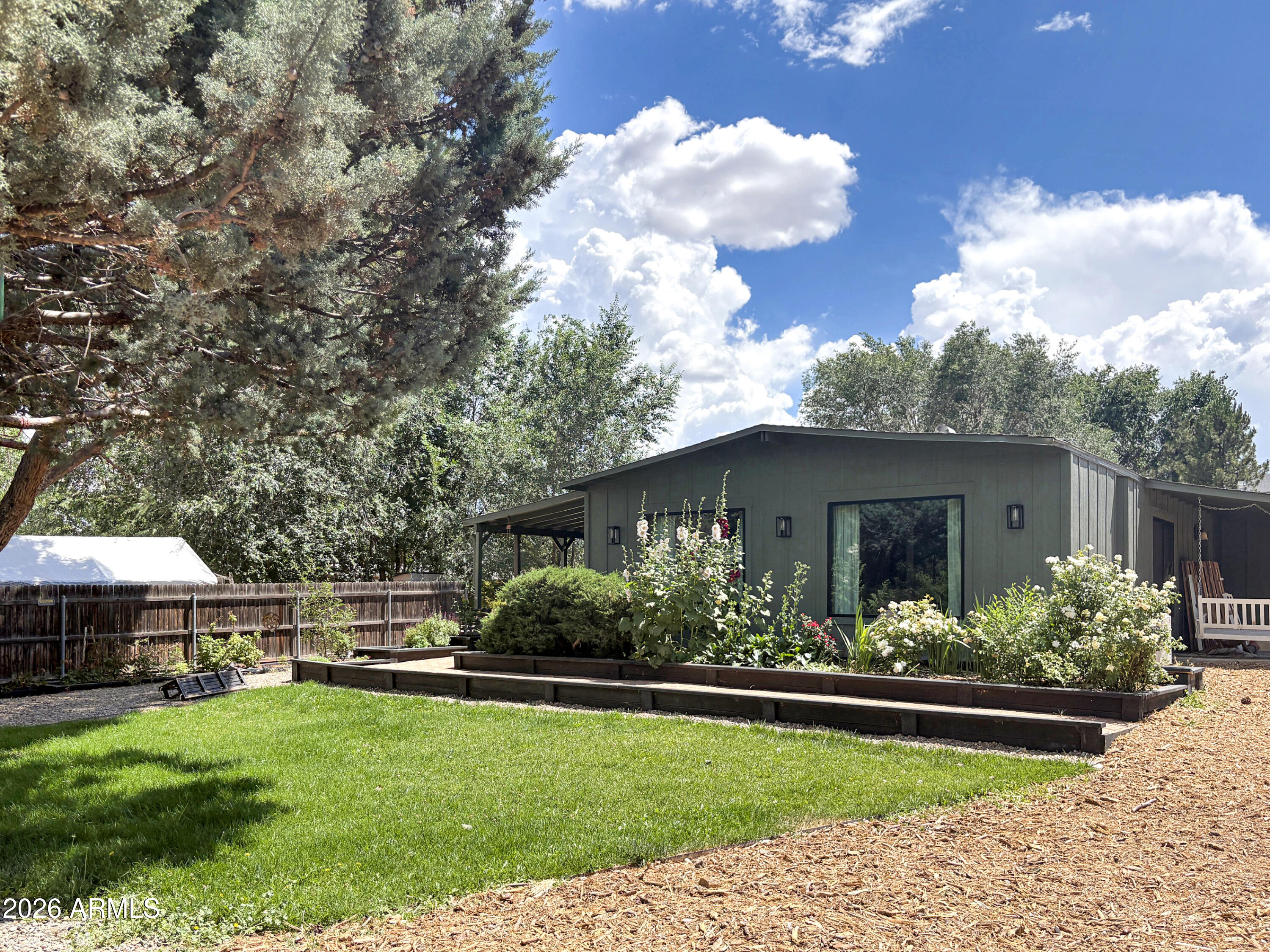 THIS UNIQUE HOME has undergone extensive updates and remodeling. Work in progress. 3-BDRMS, 2-BATHS. Approximately 1,900 SF, with built-in shelving throughout. Improvements include newer stainless steel kitchen appliances and a washer/dryer (2022), a mini-split (2022), and newer windows and exterior siding (2023/2024). Plumbing (galvanized pipes replaced with PEX) was updated in 2016. Separate sauna building. Custom wooden playhouse. Nestled in a cul-de-sac on a .37-acre lot. Chicken coops and raised-bed gardens. NO HOA. Airbnb and short-term rentals OK. Country living but close to everything! Only 20 minutes to Historic Downtown Prescott Square.