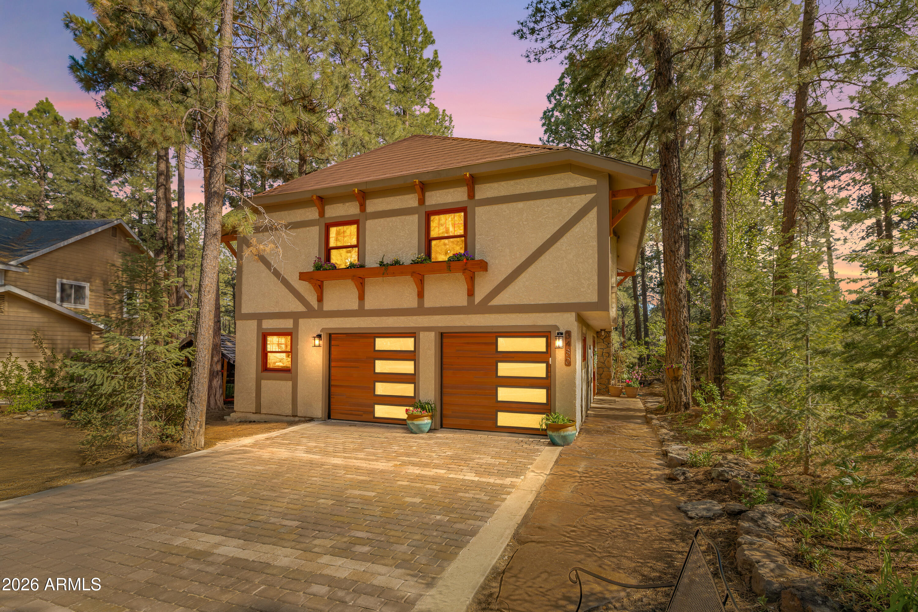 Flagstaff Sanctuary with Custom Craftsmanship & Lush Outdoor Living 
Discover a one-of-a-kind retreat nestled in one of Flagstaff's most coveted neighborhoods--where thoughtful design, natural beauty, and exceptional craftsmanship meet. This charming home radiates warmth and character, featuring a bright and airy living space with soaring ceilings, exposed beams, and a stunning stone fireplace that anchors the heart of the home. Flooded with natural light through premium Pella wood windows, every corner of this residence feels inviting and serene. Step outside onto a beautifully crafted 1,200 sq ft private deck--an entertainer's dream--complete with privacy railing and tranquil views of a lush backyard tucked among majestic Ponderosa pines.

The outdoor space is a true oasis, home to more than 25 mature trees including rare cork bark firs, plus fruit-bearing peach, apple, and cherry trees. Blooming perennials, custom hardscaping, and manicured landscaping create a picture-perfect garden setting for peaceful mornings and lively gatherings alike.

Located on a quiet street, just steps from Demiguel School, a public park, and Flagstaff's renowned Urban Trail System, this home offers adventure at your doorstep--with easy access to national forest trails, local restaurants, shopping, and downtown charm.
This is more than just a home--it's a handcrafted haven designed for comfort, connection, and a life well-lived. Come experience the magic for yourself.