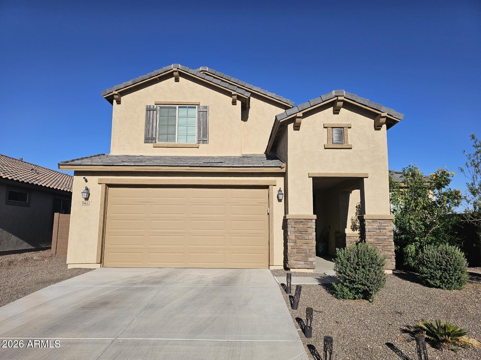 Welcome to this beautiful two-story home in Laveen, offering both functionality and modern design. As you enter, you are greeted by a versatile flex room, currently used as a workout space--perfect for a home office, gym, or playroom. This thoughtfully designed home features two guest suites, one upstairs and one downstairs--each with its own private bathroom, ideal for multi-generational living or hosting guests. The entry hallway showcases an elegant tray ceiling, leading you into the spacious living room with soaring ceilings and large windows that fill the space with natural light. The main living areas downstairs feature durable stone flooring throughout (excluding the flex room), adding both style and easy maintenance. The gourmet chef's kitchen is a true centerpiece, complete with with white quartz countertops, a gas cooktop, stainless steel exhaust hood, navy blue cabinetry with soft-close features, and a white marble backsplash.

Additional upgrades include enhanced flooring in the primary bathroom and modern wood-style railing along the upstairs loft. The second level offers a guest bedroom with a private bathroom, a spacious loft, and two additional bedrooms connected by a hall bathroom.

Conveniently located downstairs, the laundry room includes a fresh air vent control system. The home is also pre-wired for exterior security cameras, with all wiring centralized in the laundry room for easy access.

This home combines comfort, style, and thoughtful upgrades--be sure to view the photos for additional details!