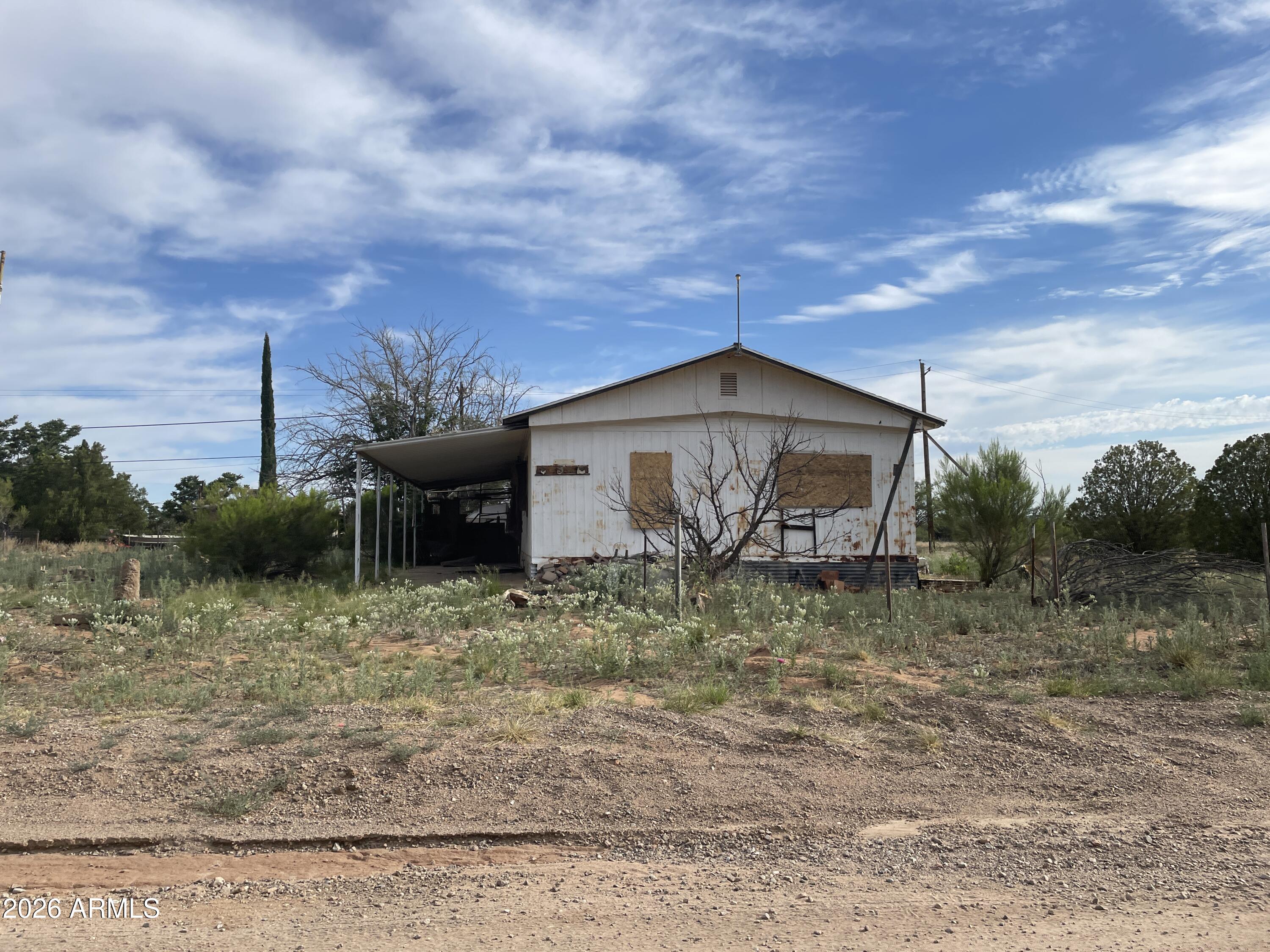 Corner lot with older mobile home. 17,395 sq ft in Miracle Valley Unit 2. Facts and figures are estimates, seller does not have any records regarding size or amenities. Needs work. Sold AS-IS. Seller will carry the loan.
