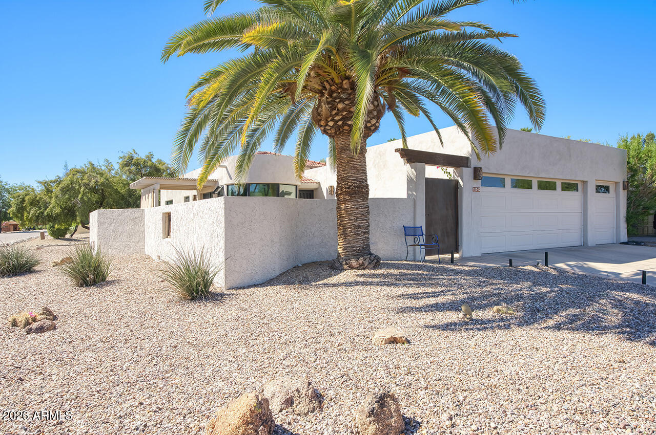 Mountain views in this unique corner lot with patios enclosed by block wall. Fully remodeled in 2023. This Open floorplan has new wood floors, wood ceiling accents and room to expand master bedroom. New carpet and walk in closets for both bedrooms. Kitchen has  new stainless appliances and quartz counters. New custom windows in expanded breakfast area. No steps, 2car + golf cart garage. Privacy and comfort.