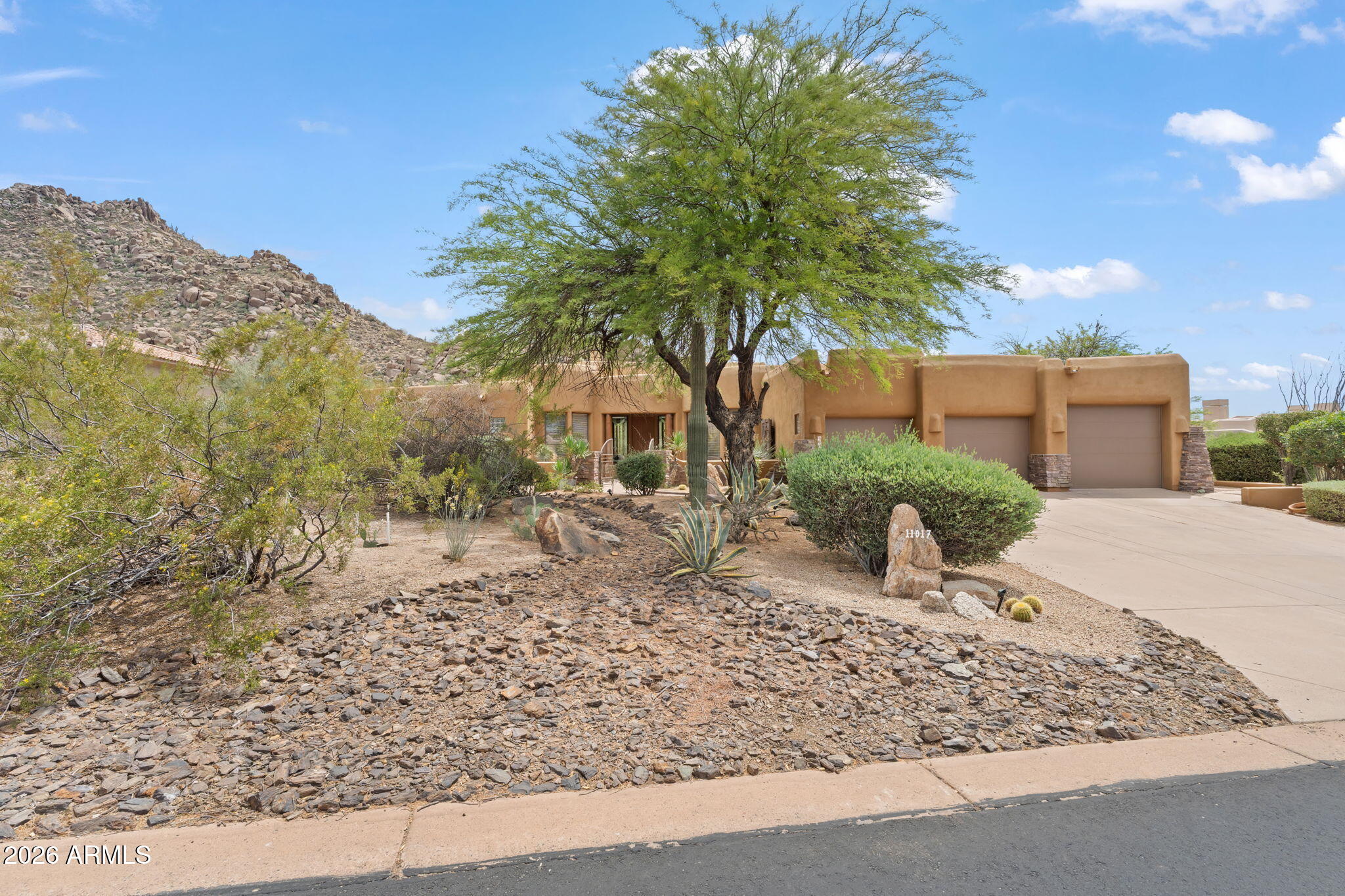 Exceptional single-level home in Troon Village offering breathtaking mountain and Pinnacle Peak views. Boasting 3 spacious bedrooms, private office, and 3.5 elegantly appointed bathrooms, blending comfort with sophistication. Engineered hardwood floors flow throughout the open-concept living spaces, creating timeless style and warmth. Beautifully updated chef's kitchen features crisp black-and-white cabinetry, striking gold accents, and gleaming quartzite countertops, perfect for entertaining and everyday living. Seamlessly blending indoor and outdoor living, the dramatic 10-foot-tall, 6-panel sliding glass door opens to a resort-style yard complete with a sparkling play pool, spa, BBQ, outdoor fireplace, and panoramic sunset views.  Experience Arizona luxury living at its finest.