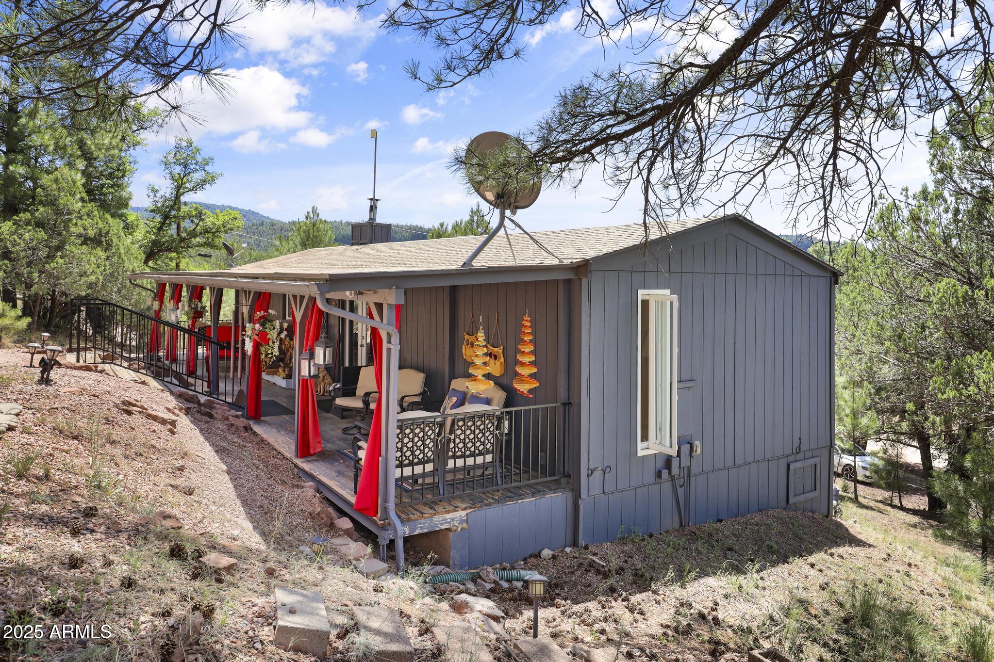 Tucked away and perched above the surrounding tall pines in Colcord Mountain Estates - just 30 minutes east of Payson - this extensively updated 2-bedroom, 1-bath gem offers the perfect blend of serenity and style. Situated on a generous ½ acre lot with sweeping mountain views, it's your very private haven in Arizona's Majestic Rim Country. The open floor plan features vaulted ceilings, a wood-burning stove, beautiful flooring, and many modern upgrades. The big picture window in the living room captures the awesome views from the comfort of your interior living space. There is BIG, LONG Covered patio and the expansive 3-car garage has a dedicated workshop bay for your projects and hobbies. Whether you're seeking a full-time retreat or a weekend escape, this Cozy Colcord Cabin delivers...
