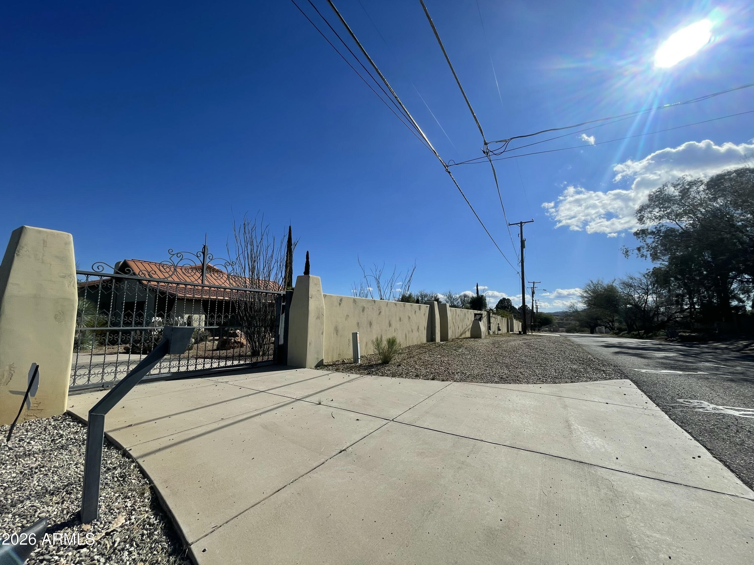 This unique 3,765 sq.,ft., gated estate, situated on a 1.65-acre lot, offers luxurious living with a private pool, built in Barbecue grill, stunning views and 2 detached guest homes 1 Bed  rm., 1 Bath rm., Inside main home vaulted  ceilings, enjoy marble counter tops in kitchen and bathrooms, 2 master suites, custom built in bookshelves, and a formal dining area, making it perfect for family gatherings. Ample covered and uncovered parking throughout, room for your RV and all your oversized motorized toys. With potential of rental income, or Airbnb no HOA.