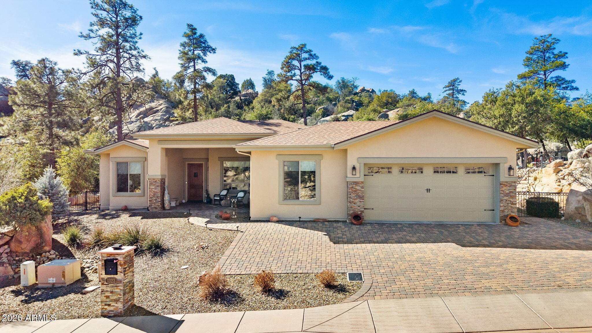 Welcome to the Preserve at Prescott, a highly desired community where privacy, nature, and comfort come together. Built in 2017, this pristine, meticulously maintained home offers 2,606 SqFt of living space with 4 beds, 2.75 baths, and 2-car garage situated on a spacious 1.28-acre lot. Nestled within this much sought-after community, the home enjoys a quiet, peaceful setting surrounded by native ponderosa and piñon pine trees, with breathtaking views of the Bradshaw Mtns. Multiple backyard paver terraces provide the perfect setting to take in mountain scenery and unforgettable sunsets, while abundant wildlife throughout the community enhances the serene Prescott lifestyle. For the adventurer nearby Centennial Trail access provides a well-marked, maintained trail w/petroglyphs and city views.
Inside, the home features 10' flat ceilings, stained beamed dining rm ceilings and porcelain plank tile flooring throughout the main living areas. The great rm is anchored by a stunning travertine ledgestone gas fireplace, creating a warm and inviting focal point. The well-appointed kitchen offers granite countertops, knotty Alder cabinetry w/soft-close drawers, large island, pendant lighting, tile backsplash, built-in microwave (2026), gas cooktop, and a walk-in pantry w/etched-glass doorideal for everyday living and entertaining. Generous living spaces and a flexible floor plan include a 4th bedroom that can easily serve as an office.
The primary suite is a true retreat, featuring a no-step walk-in shower, granite vanities, and a spacious walk-in closet. Step outside to enjoy the private saltwater hot tub, perfect for relaxing under the stars. Additional highlights include a paver driveway, decorative wood soffit cladding at porch/patio, extra storage space, and rain gutters. Exterior repainted in 2025. Conveniently located just minutes away to shopping, historical downtown and Dignity hospital, this home offers the perfect balance of seclusion, scenery, and accessibility.