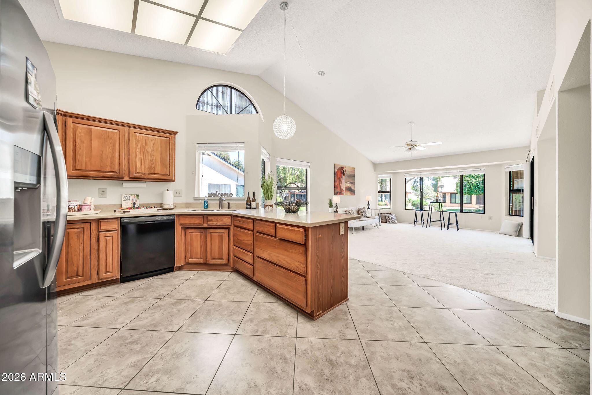 Enjoy easy living in this beautifully maintained Aspen model offering 1,866 square feet of bright, comfortable living space. Featuring 2 bedrooms and 1.75 baths, this inviting home welcomes you with vaulted ceilings, abundant natural light, and an open floor plan designed for both everyday living and entertaining. The spacious kitchen includes Corian countertops, newer appliances, and a built-in office area perfect for working from home, managing household tasks, or enjoying your favorite hobbies. Major updates provide peace of mind, including a newer roof and A/C system installed in 2019. Step outside to enjoy the serene greenbelt setting, where mature landscaping, added privacy, and peaceful views create the perfect place to relax.