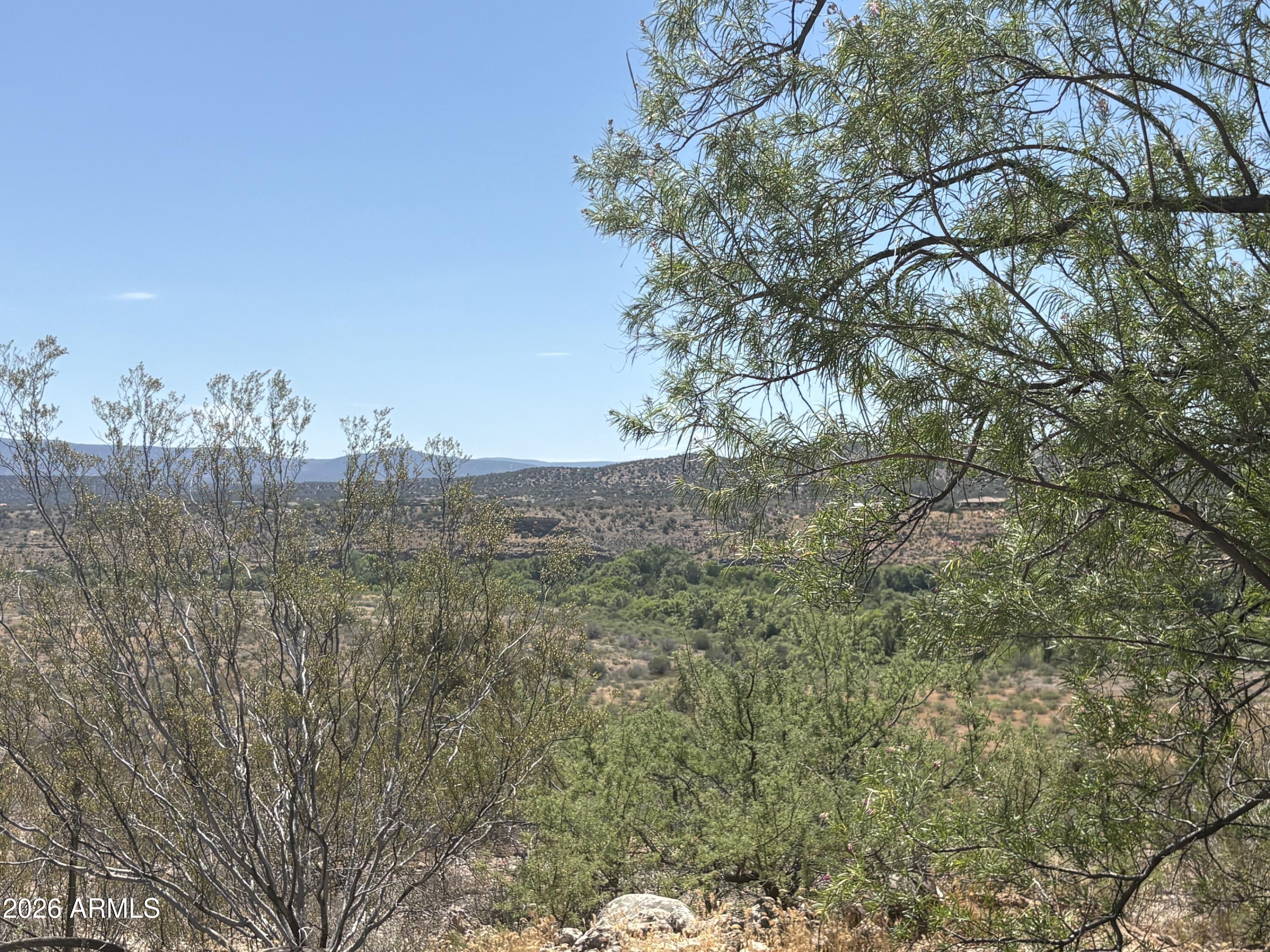 RARE OPPORTUNITY ON 2.28 ACRES IN RIMROCK, AZ! 3-BDRM + DEN Manufactured Home with a 40x60-foot detached garage featuring high ceilings and overhead doors. Ideal for a home-based business, RV parking, or car storage. The property also includes three 8x12 storage sheds.  New Septic Tank. There is a private well, and horses are welcome. GORGEOUS VIEWS FOR MILES! The updated home features 2,176 SF with a large kitchen/dining area with all appliances, updated light fixtures, vaulted ceilings, and a den/office that could serve as a 4th bedroom. Fresh interior paint. A large covered patio offers a perfect spot to enjoy the views and privacy of this exceptional property. Home has Leased Solar, the lease will be paid off by the seller at closing