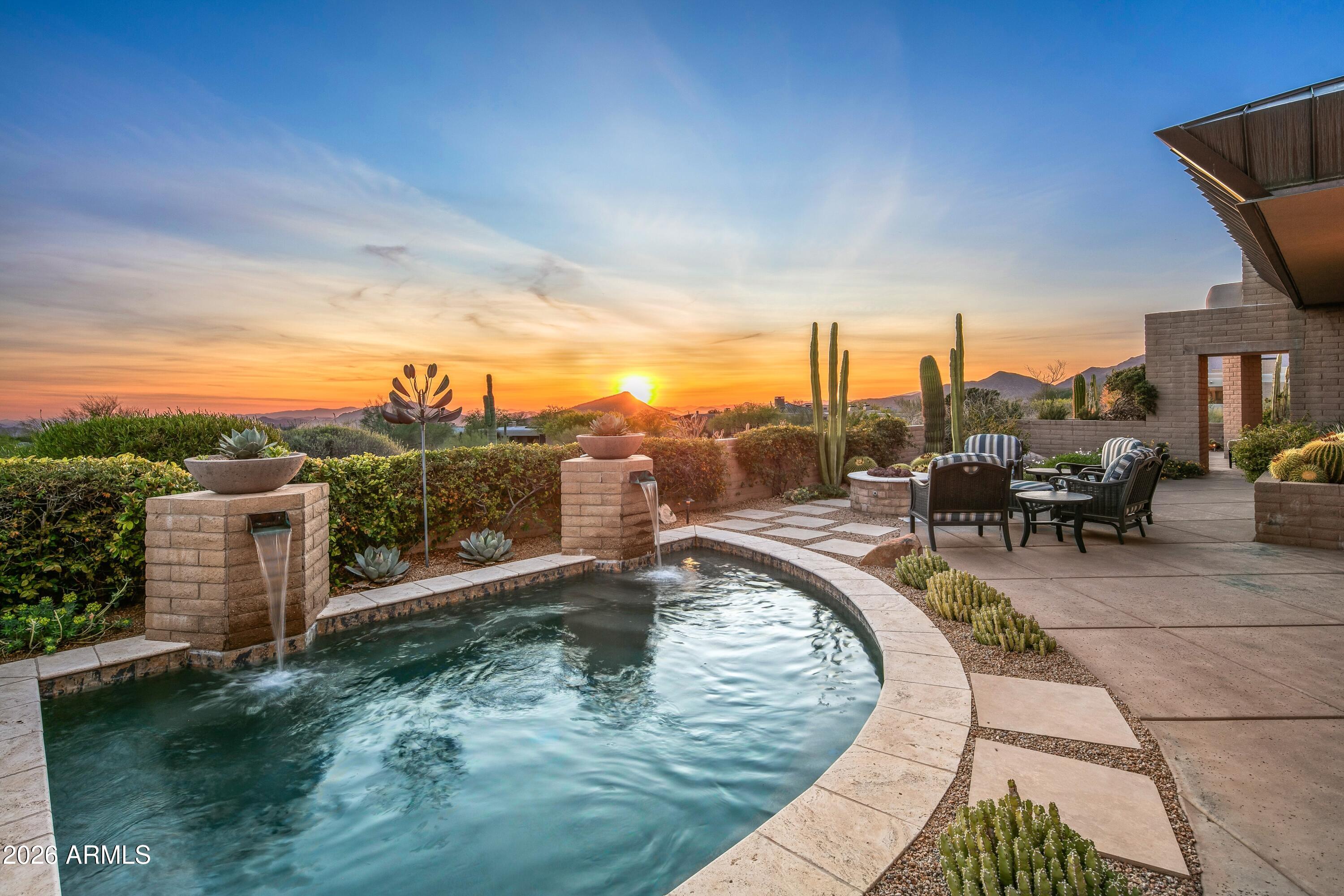 Golf Membership -Panoramic sunsets,
picturesque mountain ranges, and twinkling city
lights of Scottsdale and Phoenix define this
elevated residence perfectly positioned at the
top of Desert Mountain's Village of Desert
Horizons.

The home captures breathtaking southern
through northwestern vistas and showcases
timeless architecture, spacious living areas,
privacy from neighboring homes and
exceptional indoor-outdoor living.

The wow factor of expansive down mountain
vistas greets you as you enter the home, as the
living room and adjacent dining area are
bordered by expansive glass windows. A bright
and open kitchen/breakfast area and family
room provide a separate living area in the Frank
Lloyd Wright inspired design of the home. The
kitchen is equipped with custom cabi appliances and an island with seating
for three that often becomes the center of
entertaining.

The primary suite is privately situated on the
west side of the home and offers wonderful
down mountain sunset and city light views. The
spa inspired primary bath features heated
floors, a walk-in shower, jacuzzi tub, dual
vanities and a custom walk in closet.

On the opposite side of the home are two large
bedrooms, each equipped with their own
bathrooms. The main house also boasts an
office with built-in cabinets and draws. It could
serve as a fifth bedroom as it has its own
ensuite bath.

The main house also includes an impressive
home theatre with seating for eight, a 120 inch
movie screen and high-fidelity surround sound
delivering an exceptional cinematic experience.

The driveway into the home offers expansive
turnaround space. The air-conditioned, 3 car
garage sports EV charging and ample storage
closets for holiday displays, golf and hiking
equipment and Costco backup supplies.

A detached spacious and inviting casita
welcomes special guests as it includes a sitting
room with beverage refrigerator, large sleeping
area, dual sink bathroom and separate patio
with golf course views.

The home provides expansive patios and
covered areas ideal for alfresco dining and star
gazing. Amenities include a 12 person spool,
fire pit and soothing water feature all focused
on the down mountain panoramic vistas.

High end finishes are found throughout the
home due to recent remodeling, including
hardwood reclaimed flooring, tiled bathrooms,
stone countertops, premium appliances and
Sonos music throughout the house and patios.
Four fireplaces, vaulted ceilings, sump block
indoors and outdoors and extensive glass
define the architectural spirit of this home.

Ideally located mid-mountain, the property
offers convenient access to both guarded gates
and Desert Mountain's renowned amenities,
including seven golf courses, seven

clubhouses, pickleball, the Sonoran Fitness
Center and Spa, and more than 24 miles of
scenic hiking trails bordering the Tonto National
Forest.

This remarkable home offers the ultimate
Desert Mountain lifestyle, where extraordinary
views, refined design, and seamless indoor-
outdoor living come together in one exceptional
setting.