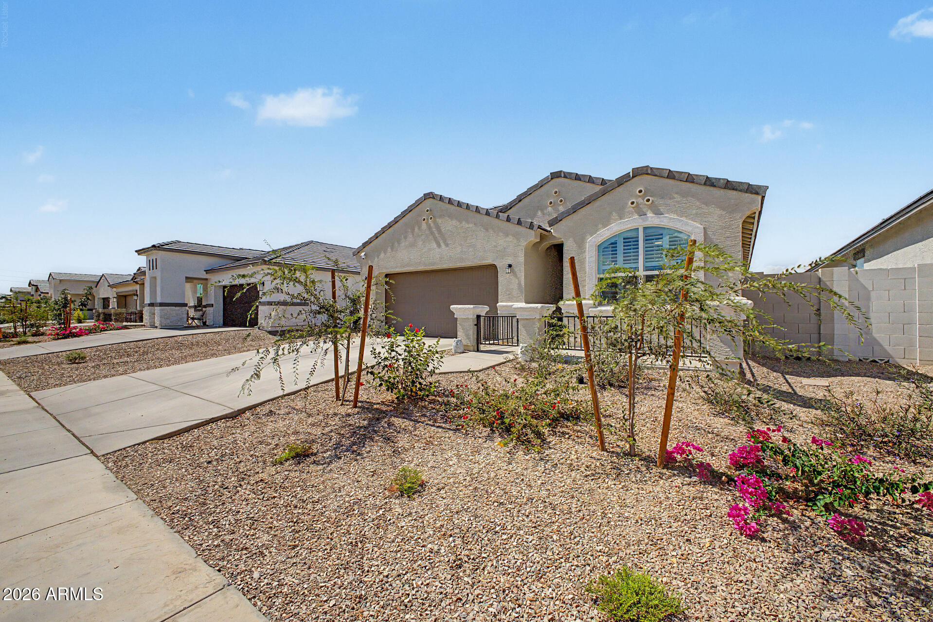 Better than new! This 2025 DR Horton Mockingbird offers 4 bedrooms, 2 baths, 1,788 sq ft, North/South exposure, and over $100,000 in premium upgrades. Enjoy a stunning PebbleTec play pool with stacked stone water feature, smart controls, color-changing lighting, travertine decking, and pre-wired for a pool heater. The professionally designed backyard features 644 sq ft of pet-friendly turf, RGB landscape lighting, citrus trees, palms, and a double gate. Inside, you'll find upgraded granite counters, designer backsplash, matte black hardware and fixtures, plantation shutters, floor-to-ceiling curtains, added recessed lighting, RO system, water softener, EV-ready garage, and washer/dryer included. Move-in ready and conveniently located near I-10, shopping, dining, and Costco.