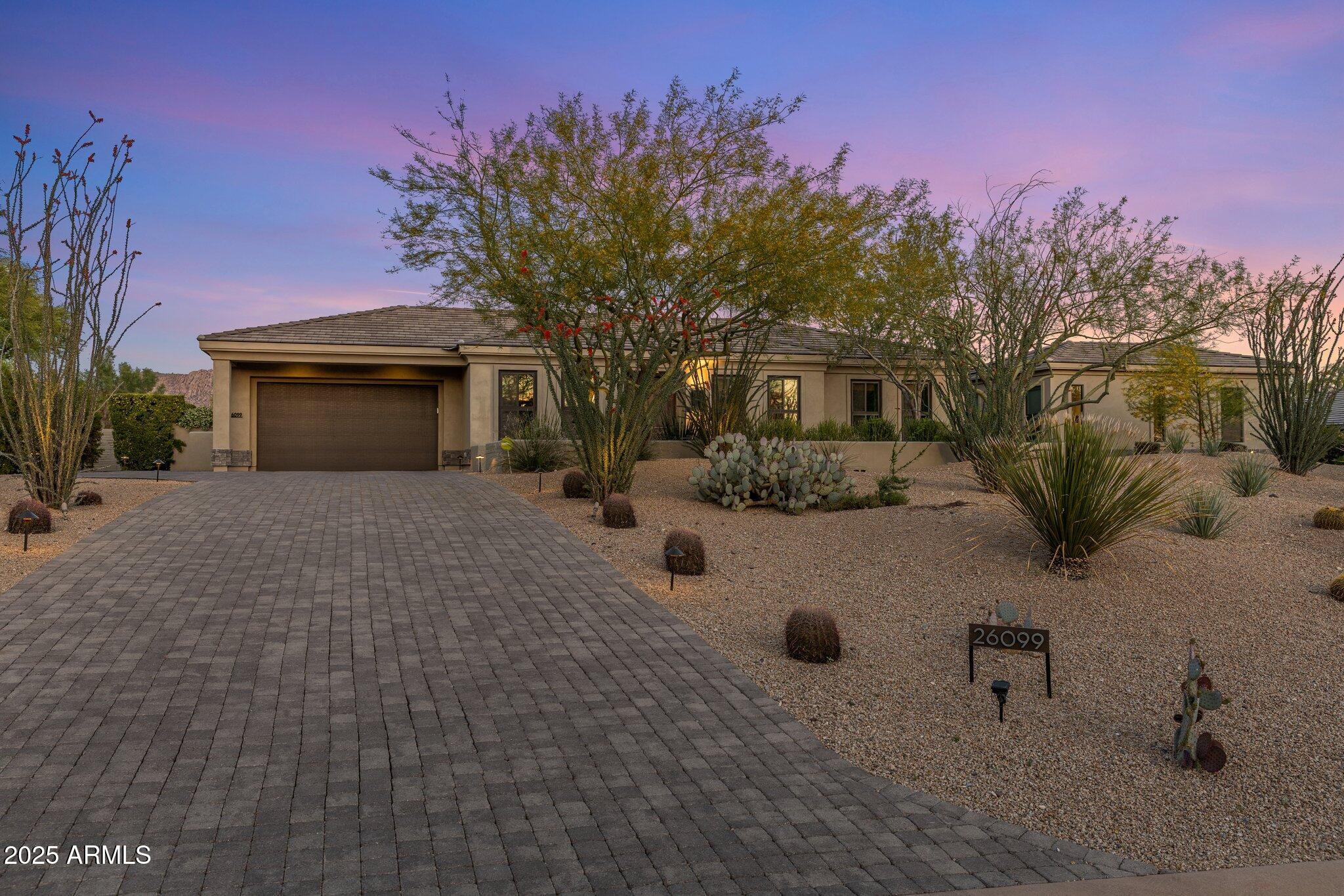 Situated on nearly an acre lot within the gated community of Pinnacle Peak Place, this contemporary single-level residence offers an exceptional lifestyle. The home features five bedrooms, 4.5 bathrooms, and 4,484 square feet of thoughtfully designed living space with European influences. Custom hardwood flooring and crown molding define the open floor plan, creating a refined and inviting atmosphere for everyday living and elegant entertaining. The gourmet kitchen is a chef's delight, equipped with European-style cabinetry, a waterfall island with limestone countertops, Bosch appliances, and a butler's pantry. Expansive folding glass doors extend the living space to a resort-style backyard complete with a heated pool, spa, built-in firepit, and putting course - perfect for Entertaining and relaxing. The primary suite provides a luxurious retreat, featuring a custom walk-in closet, oversized soaking tub, dual vanities, a walk-in shower, and private access to an additional outdoor shower. A detached guest casita with a private entrance adds versatility, while a 3-car garage caters to convenience. A recently installed tankless gas water heater and a water softener ensure modern comfort and efficiency.  Ideally positioned in Scottsdale, the home grants convenient access to hiking trails, premier golf courses, fine dining, and upscale shopping.