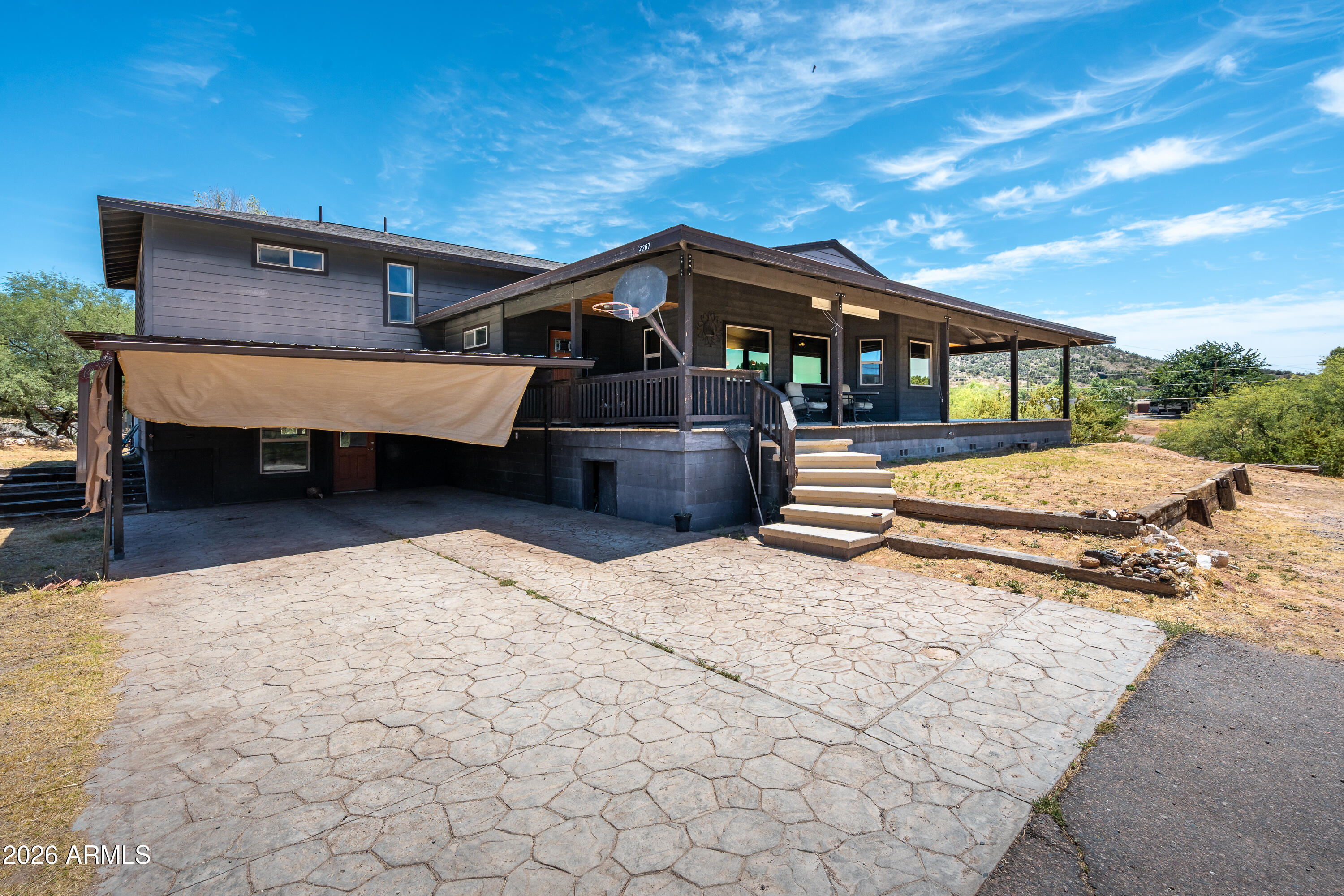 Enjoy space, both inside and out! This 3627 Sf home situated on .97 acres is currently set up as a 2,235 SF main house and 1392 Sf guest house, while currently separated, the property is framed to allow joining both sides together to make one large home. Set up as a 3 bed 2 bath main house and a 1 bed 2 bath guest house, it was designed with flexibility. Inside the main house you will find engineered hardwood floors a large kitchen with granite counters, down stairs rec room and upstairs bedrooms! Enjoy the massive wrap around deck with fantastic mountain views. Space to park your RV, bring your horses, goats, sheep chickens and more! Great property for multi-generational, vacation rental income and more! New roof in 2025 with transferable warranty!