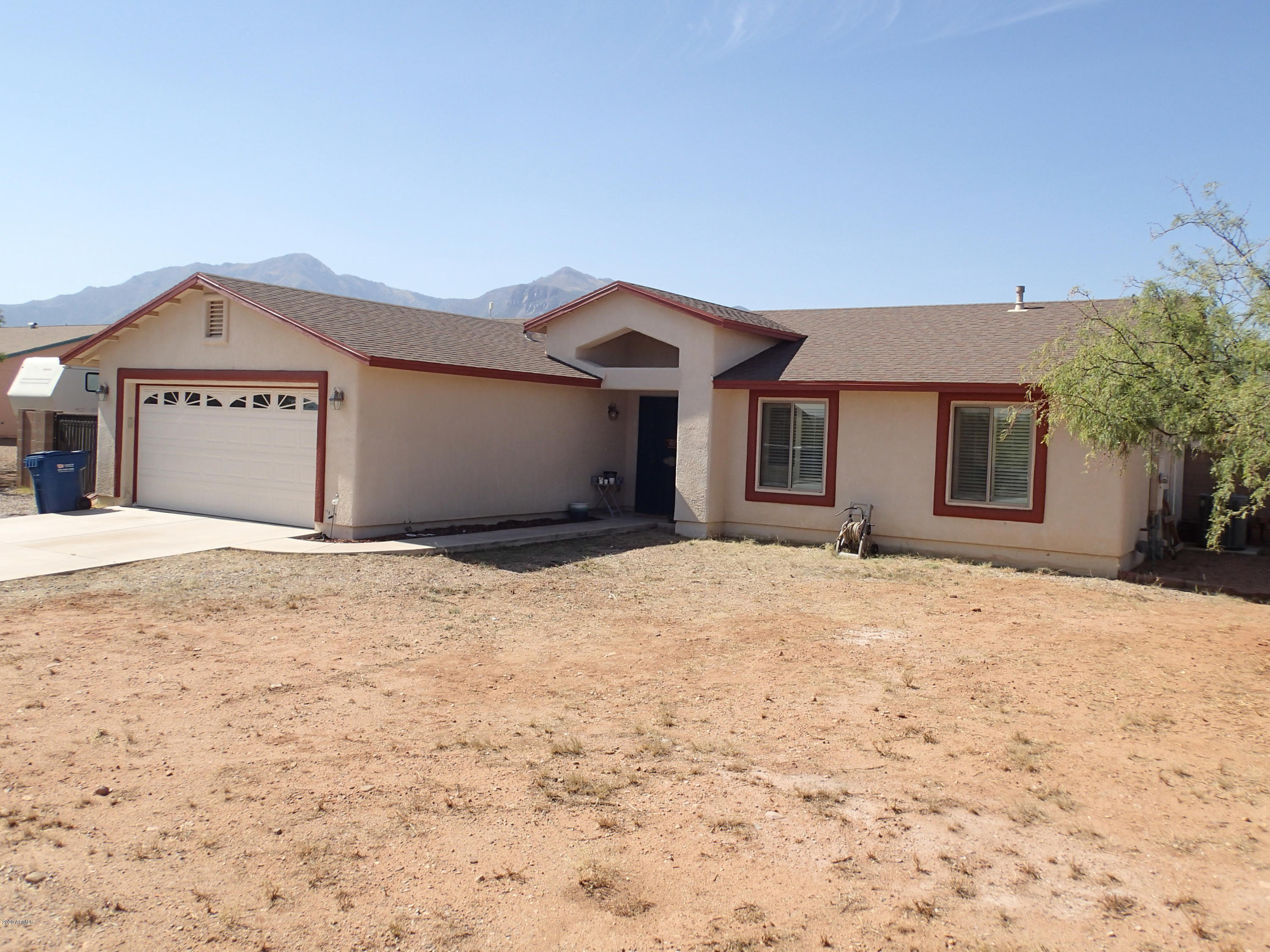 AWESOME MTN VIEWS from this private 1 acre parcel!! Located one parcel in from paved Ramsey Rd. This 3br/2ba/2 garage built in 2004 has ALOT to offer. From it's HUGE  kitchen with island and custom pullout in cabinets, to the Porcelain Wood Tile. Newer Stainless Steel double door Refrigerator. Two Pantry closets.  Freshly painted inside. Electric stove and plumbed for gas.  Easy care custom shutters in 2 bedrooms.  Large dual pane windows provide lots of light and Mtn views adding to the comfortable feel of this home.  Full 6ft Block wall enclosed private back yard with Grass (Irrigation installed)and new Evergreen trees. Iron gates for your toys. Plus, a barn style shed with loft.  Must see, will not last.....