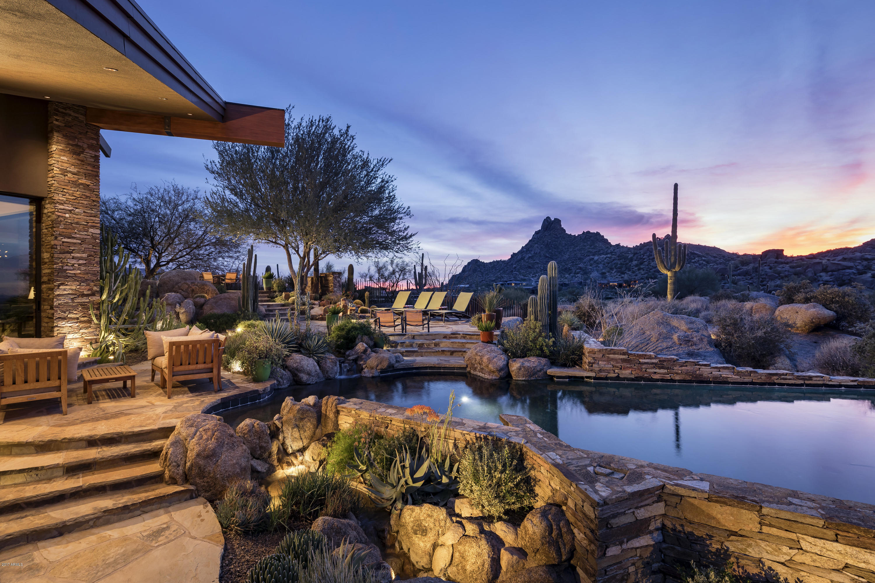 PERCHED ABOVE THE 17TH FAIRWAY OF WORLD- RENOWNED ESTANCIA GOLF CLUB, THIS HOME IS IMPECCABLE IN EVERY WAY. BRILLIANT ARCHITECTURAL DESIGN ELEMENTS INCLUDE A COPPER ROOF, DRAMATIC WALLS OF GLASS, SOARING CEILINGS, EXTENSIVE ART LIGHTING AND A HUMIDIFICATION SYSTEM THROUGHOUT TO PRESERVE ARTWORK. FINE FINISHES AND  LUXURIOUS DETAILS ARE EVIDENT-STONE, COPPER AND WOOD ACCENTS, VOLUMINOUS LIVING SPACES,TRANQUIL MASTER RETREAT,THREE ADDITIONAL EN-SUITE BEDROOMS AND SEPARATE GUEST CASITA. IN PERFECT HARMONY WITH ITS EXPANSIVE DESERT SURROUNDINGS, THIS CUSTOM HOME BOASTS INCREDIBLE OUTDOOR ENTERTAINING SPACES, ENDLESS MOUNTAIN VIEWS, AWARD WINNING RESORT-STYLE WATER FEATURES AND LANDSCAPING. ENJOY THE BEST OF A PRIVATE AND RELAXED DESERT LIFESTYLE. *PLEASE WATCH HD VIDEO TOUR UNDER PHOTO TAB*