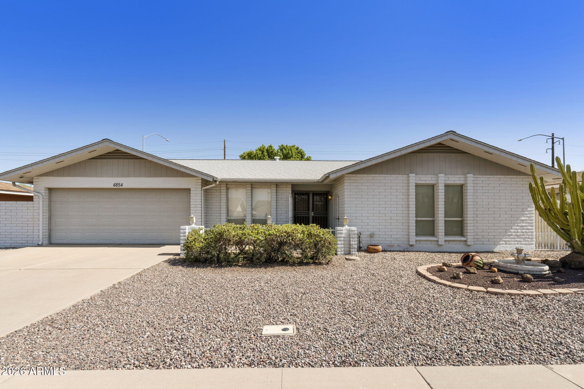 Welcome to this 55 plus gem in Sunland Village 2. In this home you will find 1962 sq ft of space w/3 bds/2ba, eat-in kitchen as well as formal dining, greatroom along with an AZ room & inside laundry. The galley kitchen features a wall oven, pantry, electric stove top, laminate counters with stone backspash. Greatroom & Az room have sliders w/built in blinds to access backyard. Primary bdrm has walk in closet, primary bath w/shower and extra linen storage. 2 car garage with golfcart storage. Backyard with turf & covered patio. New rooof was done in 2014, exterior painted 2017, New AC unit in 2019,  added insulation in the attic 2017. This home was well taken care of and is in need of another loving homeowner to enjoy the ammentities and neighbors this community has to offer. Don't miss out