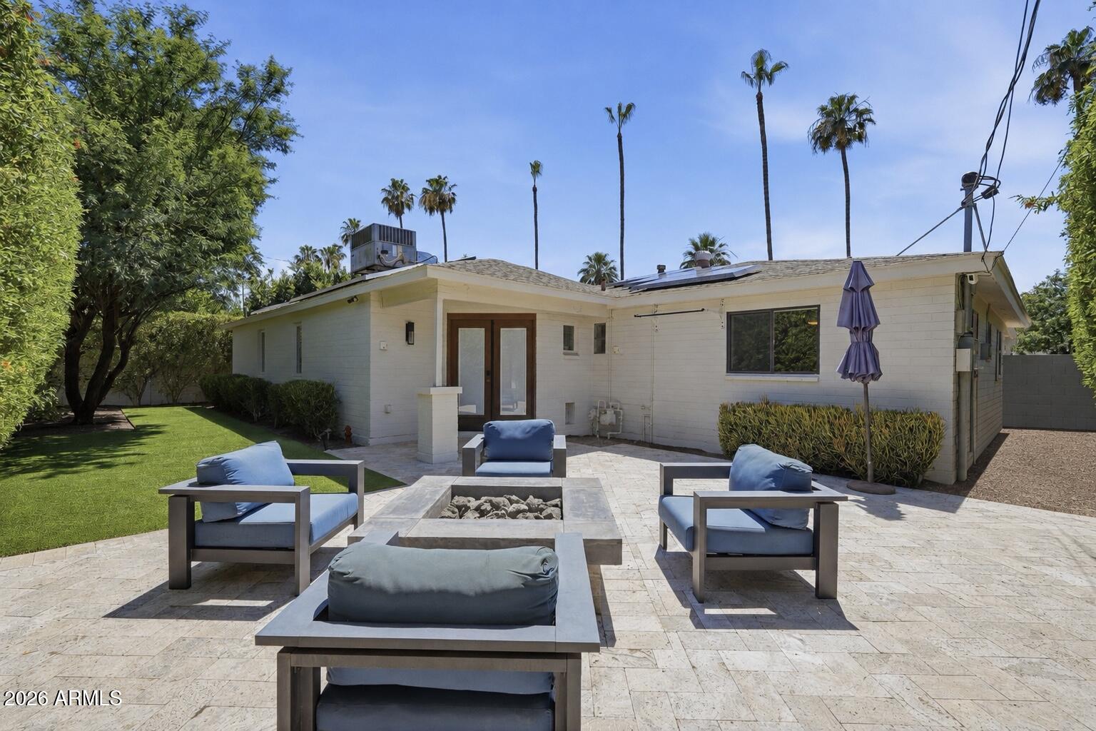 Amazing Arcadia Lite location on a palm lined family-friendly street. Inside you will find gorgeous real hardwood floors flowing through a bright, open layout perfect for entertaining. The primary suite is a true retreat, featuring beautifully designed custom closets and a double-sided gas fireplace between the bedroom and the spa-like bathroom. Outside, enjoy a private backyard oasis featuring premium artificial turf and an inline gas firepit, offering year-round lushness with low maintenance and minimal water usage. This turn-key home features fully owned Tesla solar panels and a dedicated EV charger. This beautiful home has everything.