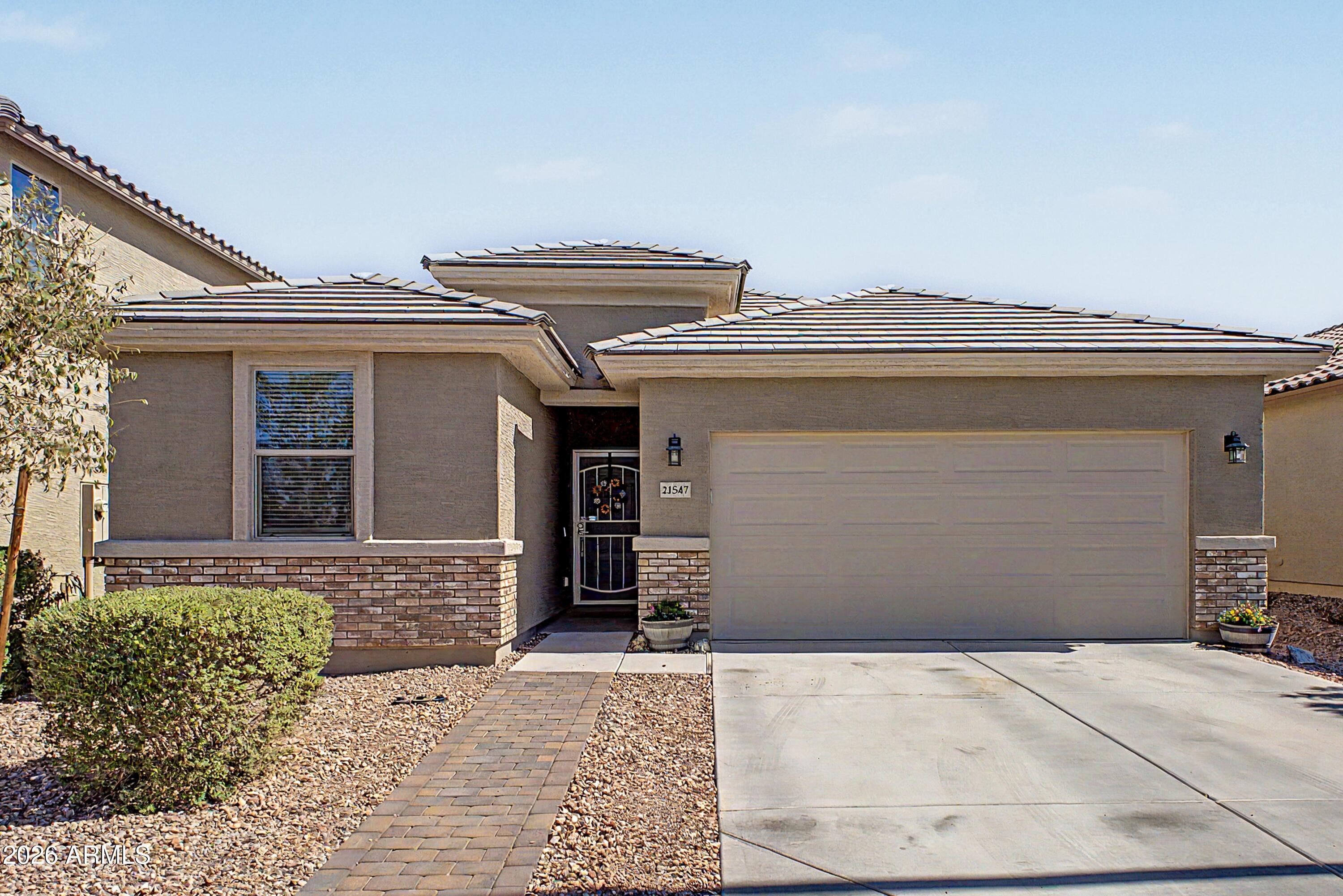 This is the one! Beautifully maintained, this 3-bed, 2-bath home with a versatile den offers the perfect blend of comfort & functionality. Inside, you'll find tile flooring t/o the main living areas, plush carpeting in the bedrooms, & designer lighting that adds a modern touch. The spacious open-concept layout flows seamlessly into a stunning kitchen featuring stainless steel appliances, ample cabinetry, a large walk-in pantry, & plenty of space for gathering & entertaining. The private primary suite serves as a relaxing retreat, complete with a spacious bedroom, walk-in closet, & an en-suite bathroom designed for comfort & convenience. Additional highlights include a 2-car garage, dedicated laundry area, & a generously sized backyard perfect for relaxing on those gorgeous Arizona days!