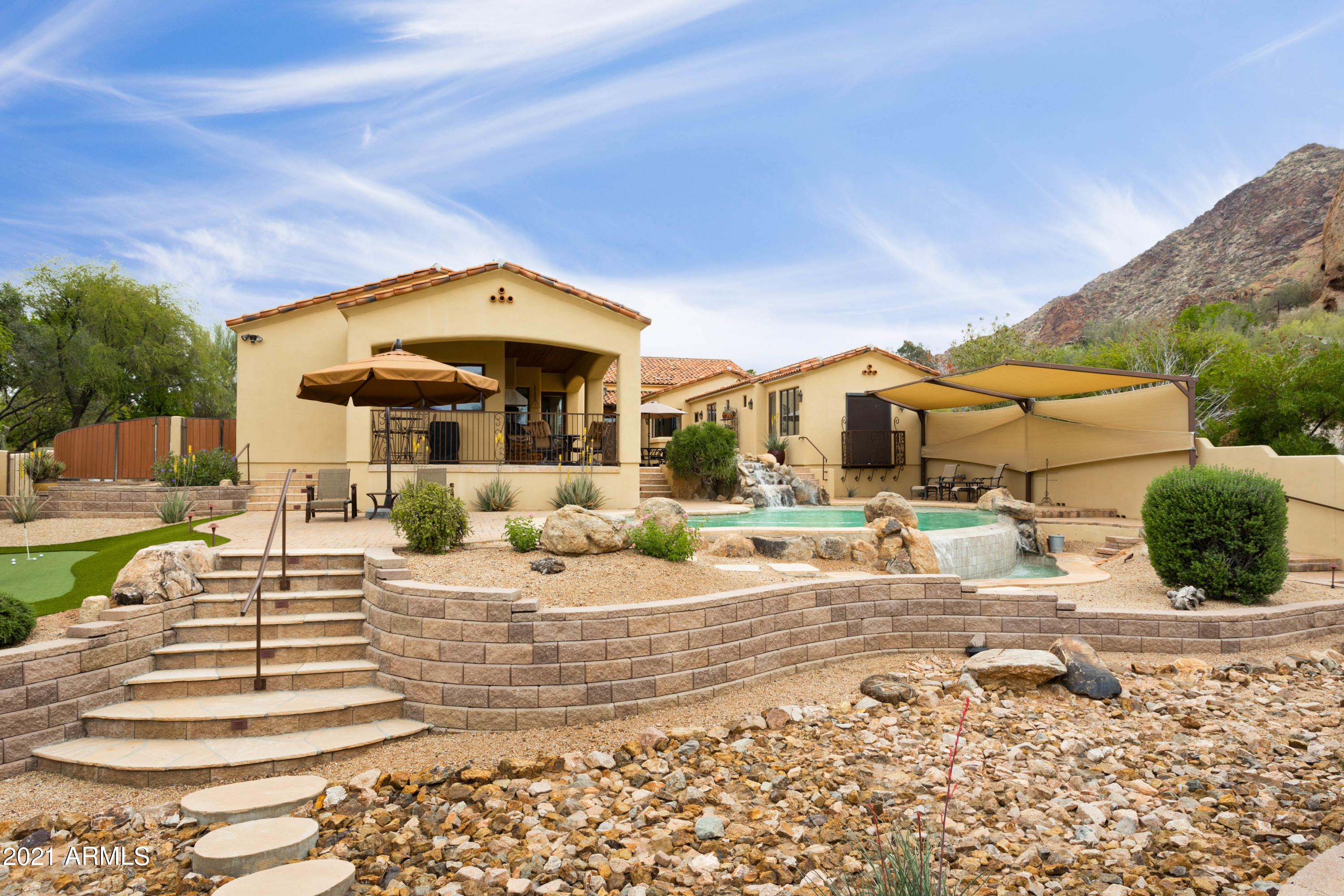 Exceptional Paradise Valley location at an outstanding value. Captivating mountain views combined with impeccable landscape create a wonderful background for this George Christianson designed home. Inside you will find beamed & wood plank ceilings offering a warm, flowing floor plan with ample space for everyone! The bright kitchen comes equipped with high end, stainless steel appliances. Great home entertainment for the family with both a media room AND a game room. The master suite includes an exercise room overlooking the pristine pool and has direct access to the large center patio. Separate guest casita and wood shop offer additional sf options. The backyard boasts two putting greens, an outdoor arroyo, terraced patios, and dramatic views.