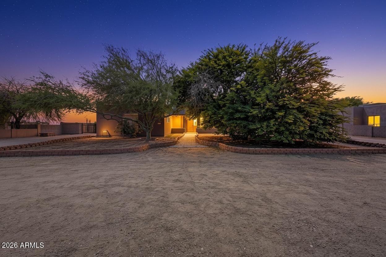 Elegant desert retreat with a magical, one-of-a-kind backyard. This spacious home offers soaring vaulted ceilings, an open light-filled layout, and a 3-car garage. A roundabout driveway and stone walkway create a charming approach to the front entry. Enjoy an entertainer's dream backyard with lush oleander trees, striking pineapple palms, ambient lighting, a sparkling pool with tranquil waterfalls, and a full vegetable garden. Peaceful full garden spaces and breathtaking mountain views create a relaxing setting for gathering or unwinding. No HOA and an RV gate add flexibility, while the serene private location feels like an escape with everyday conveniences nearby.