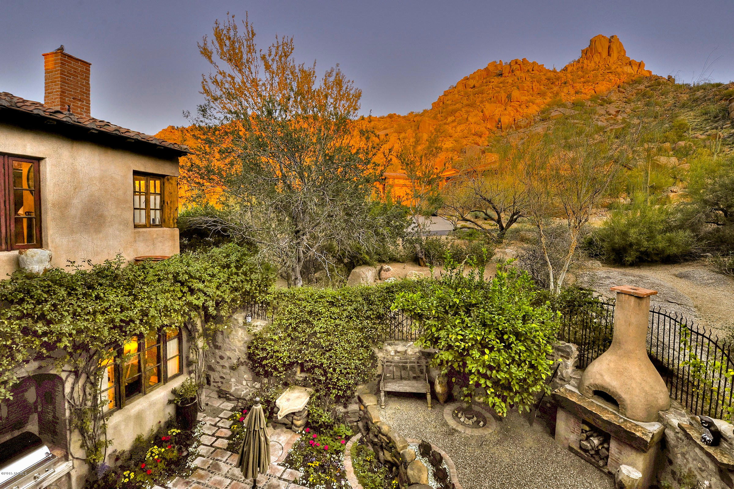 Exquisite 1.2-acre estate bursting with an authentic European ambiance. Fabulous hillside setting offers golf course, city lights & mountain views. 9 Fireplaces, Incredible finishes include reclaimed wood floors, gorgeous limestone counters, distinctive vanities, hand-plastered walls & unique ceiling treatments. 4,690 SF main residence with huge Living Room with views & antique limestone fireplace from France, Dining Room with fireplace, wet bar with wine cellar, Kitchen with  premium appliances, cozy Family Room with fireplace, artist’s studio & romantic master with exercise room. 1,250 SF 2Bedroom guest house with Living Room, fireplace & private patio. 778 SF detached office/ guest casita. Lush grounds with pool/spa, many courtyards, patios & balconies.