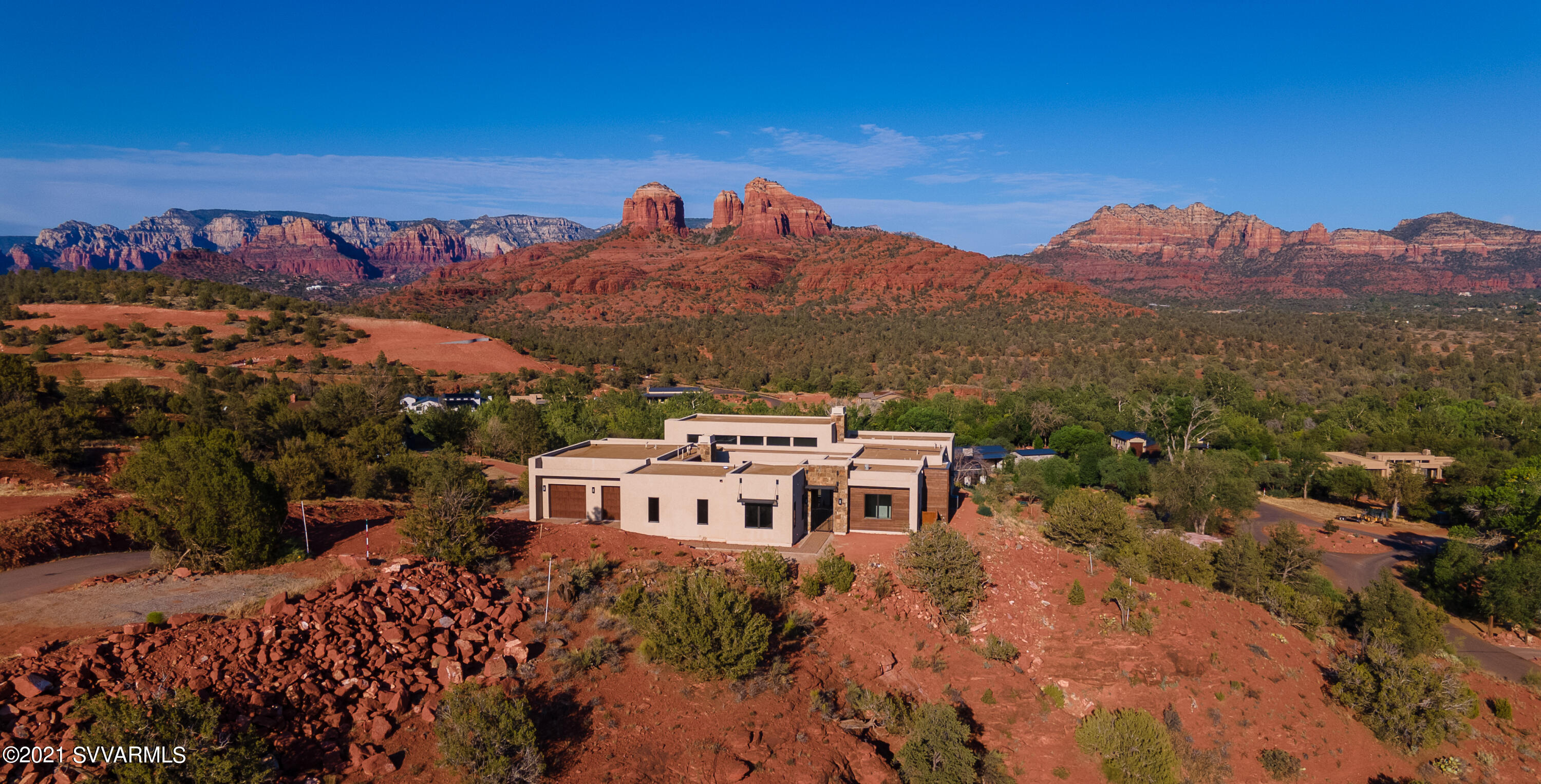 This incredible homesite offers expansive red rock scenery with direct views to Cathedral Rock! Simply and quite literally the BEST property in Sedona Ranch. This home just finished construction and has never been lived in. Landscaping is a blank slate where a buyer can create the outdoor areas they've always dreamed of: enlarge the patio, outdoor BBQ and entertainment area, outdoor game area, fountains and/or waterfall, or just imagine a negative edge pool and spa with one-of-a-kind views of Catherdral Rock! The  brilliant light shows from the rising and setting sun on the red rocks is incredible.  With a perfect layout on the property and incredible views from every window in the home, this home is everything you could dream of.
