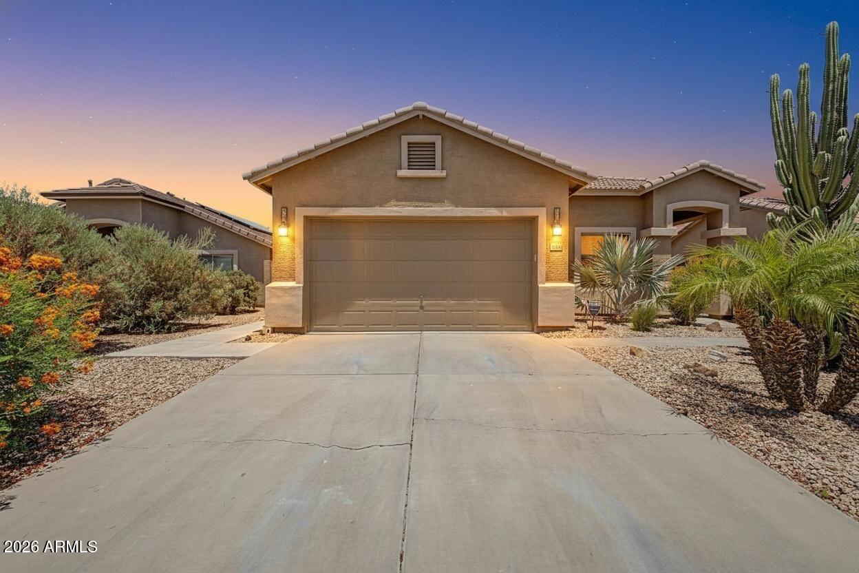 Move-in ready and beautifully maintained home in Maricopa featuring a sparkling private pool and inviting outdoor living. The backyard is designed for relaxation  sun shades on the covered patio, providing comfort and shade year-round. Inside, you'll find a flexible floor plan including a bedroom with a built-in Murphy bed and integrated office setup, ideal for guests or working from home. The home shows pride of ownership throughout with clean, well-kept interiors. Enjoy mature desert landscaping in the front for low-maintenance curb appeal. Conveniently located near parks and local amenities, this home offers both comfort and functionality.