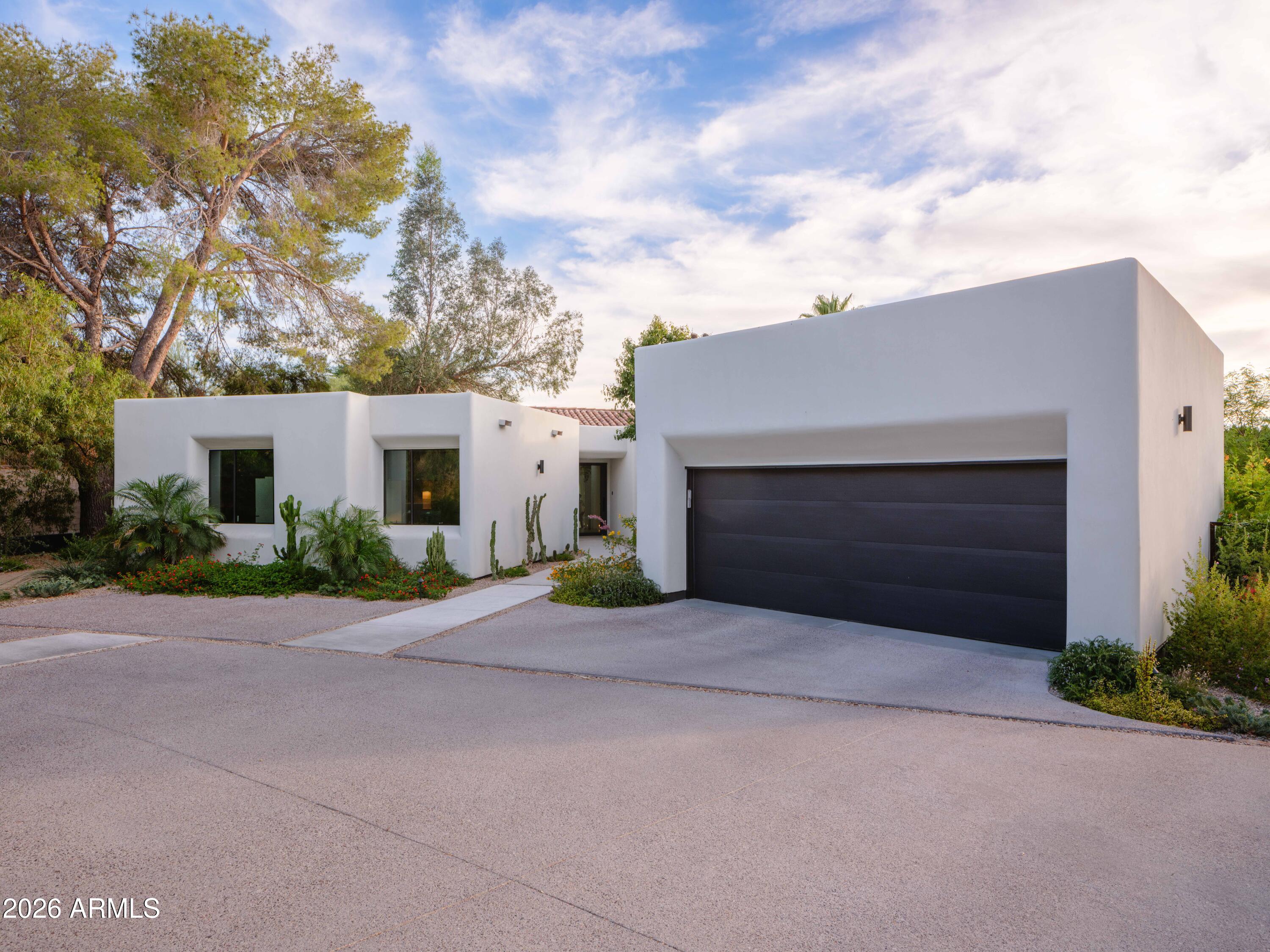 Architecturally reimagined hillside residence captures sweeping mountain, city-light & sunset views. Fully renovated w/refined desert-modern design, featuring custom steel windows/doors, oak millwork, bespoke built-ins & seamless indoor-outdoor living. Chef's kitchen w/custom banquette, premium appliances, spa-inspired primary suite, view terrace, steam showers & luxe baths. Resort-style pool, rooftop deck, curated desert landscape, extensive lighting & misting systems extend living outdoors. Smart home integration, EV-ready climate-controlled garage, tankless systems & high-efficiency upgrades ensure modern ease. Adjacent to Piestewa Peak Preserve Trailhead. Minutes to Biltmore, Downtown Phoenix & Sky Harbor. Turnkey luxury, meticulously reimagined. Rare offering defined by design! Piestewa Peak Modern - Hayes McNeil | Plus Minus Studio

A rare offering at the base of Piestewa Peak, this remarkable residence was completely reimagined by acclaimed Arizona architect Hayes McNeil of Plus Minus Studio. The result is a sophisticated expression of contemporary desert architecture, blending clean modern lines with subtle Spanish influences and an exceptional sensitivity to site, scale, and material. Custom steel windows and doors frame mountain views, city lights, and curated landscape vignettes throughout, while a thoughtfully reconfigured floor plan creates an effortless connection between the home and its surroundings. Every element was considered with intention, resulting in a residence that feels both timeless and distinctly of its place.

Inside, refined craftsmanship and architectural discipline define the experience. Rift-sawn oak millwork, custom built-ins, designer lighting, and carefully selected natural materials create interiors that are elegant, warm, and highly functional. A dramatic fireplace anchors the main living spaces, while integrated smart-home technology, motorized window treatments, Wi-Fi-enabled climate controls, tankless water heaters, and high-efficiency systems provide seamless modern convenience. The kitchen and dining spaces were designed for both daily living and entertaining, featuring a custom banquette, beverage center, walk-in pantry, and dedicated coffee bar. The primary suite serves as a private retreat, opening to an elevated terrace with sweeping sunset views over the Phoenix skyline and a beautifully appointed bath complete with a steam shower.

The outdoor environment is equally compelling. More than 300 strategically placed plantings create a mature desert landscape that enhances privacy while preserving long-range views. The pool, gardens, and outdoor living spaces unfold with the confidence of a carefully executed design project, where every detail contributes to a cohesive experience. Built-in seating areas, a poolside lounge, professional-grade misting systems, extensive landscape lighting, and a rooftop observation deck create a series of memorable spaces for gathering, relaxation, and year-round enjoyment. A historically inspired stone wall introduces texture and character, providing a thoughtful "wabi-sabi" counterpoint to the home's crisp architectural forms.

Ideally positioned near the trails of Piestewa Peak, with convenient access to the Biltmore, Downtown Phoenix, Sky Harbor International Airport, and the SR-51 corridor, the property offers a rare balance of privacy, connectivity, and architectural significance. Conceived for long-term ownership rather than resale, the quality of execution is evident throughout. Impeccably maintained and recently completed, this is a fully realized residence of enduring design, offered for those who value architecture, craftsmanship, and an exceptional way of living.
 

 FEATURES: 
Architecturally reimagined by Hayes McNeil | Plus Minus Studio
Adjacent to Piestewa Peak Preserve Trailhead
Elevated hillside setting W/ panoramic mountain and city-light views
Rooftop observation deck W/ spectacular sunset vistas
Custom steel windows and doors throughout
Refined desert-modern architecture
Resort-style pool and outdoor entertaining spaces
Published-quality landscape and outdoor design
Rift-sawn oak millwork and custom built-ins
Primary suite with private view terrace
Spa-inspired baths with steam showers
Designer kitchen with custom banquette dining
Extensive landscape lighting and professional misting systems
Climate-controlled garage with EV charging capability 
Renovation completed in 2025
Rare "flat" hillside lot
Single-level home
Built for long-term ownership, not resale