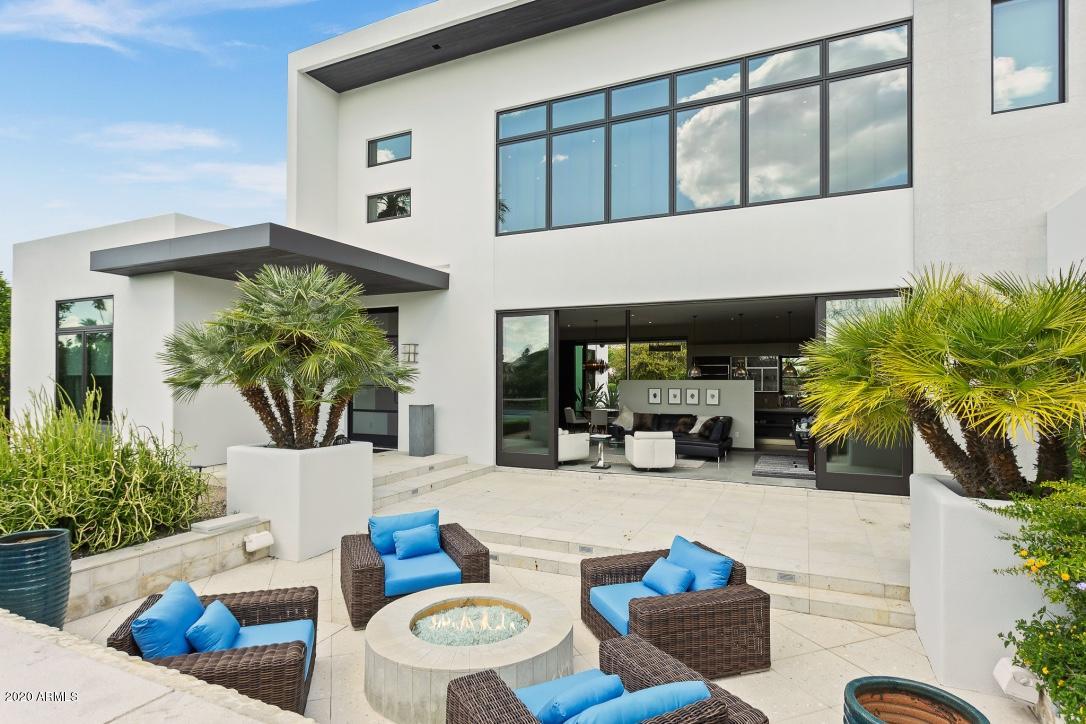 Stunning soft Contemporary home featured in LUXE Magazine, and Arcadia homes. This home sits on over 1/2 acre the heart of Arcadia with phenomenal views of Camelback Mountain. A 24 ft wide wall of glass sliding doors open up from the living room to a large private front patio and fire pit, 20ft wide water wall with smooth white pebbles and limestone. Gourmet kitchen features 48' side by side Sub Zero, 2 Miele Dishwashers, 2 Miele Ovens, 2 Miele quick combo microwave ovens, built-in 2019 Miele expresso machine, 12' long center island with custom Maistri cabinetry. Serene upstairs master includes, gym, enclosed office and resort like master bath. Steam shower, whirlpool tub, sitting area w stunning Camelback views. Entire exterior repainted in 2019, and mpartial repaint interior. Flooring completely updated in 2019. New RH light fixtures kitchen and bar and RH drapery in bedrooms and living room. 4 new Lennox HVAC units 2019, New garage HVAC units, new pool heater, this stunning home is a must see.