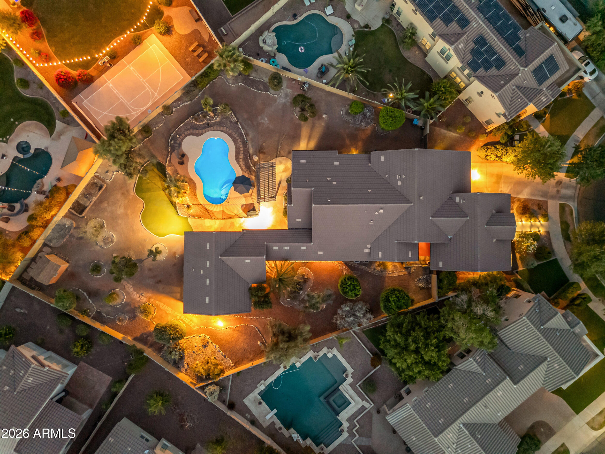 Located on a rare 1/2-acre lot in Verrado's highly sought-after Main Street District, this sprawling and immaculate professionally designed private oasis invites you to unwind and stay awhile. With generous spaces inside and out, it's perfect for quiet relaxation or hosting everyone you love poolside.

The main residence features 4 bedrooms, 3 bathrooms, and 2,693 sq ft of beautifully appointed living space. A 3-car tandem garage includes a soft water system, plus an RV gate for additional parking and storage.

An incredible 676 sq ft guest casita offers the ideal retreat for visitors or a private home office, complete with 1 bedroom, 1 bathroom, a kitchenette, and a spacious great room. Step outside to an estate-style backyard--an ultra-private sanctuary designed for year-round enjoyment and effortless entertaining. Verrado is known for beautiful homes, shady tree-lined streets, inviting front porches, and a strong sense of community for residents of all ages. With so much to do around Verrado, there are endless opportunities for neighbors to become fast friends. Resort-style pools and spas, scenic trails, beautiful parks, a fitness center, championship golf, and endless community activities all create an unmatched lifestyle.

So what exactly makes life in Verrado so special? It's a collection of wonderful little things that come together to create something extraordinary. Verrado's walkable Main Street District places shops, dining, and community events just minutes from