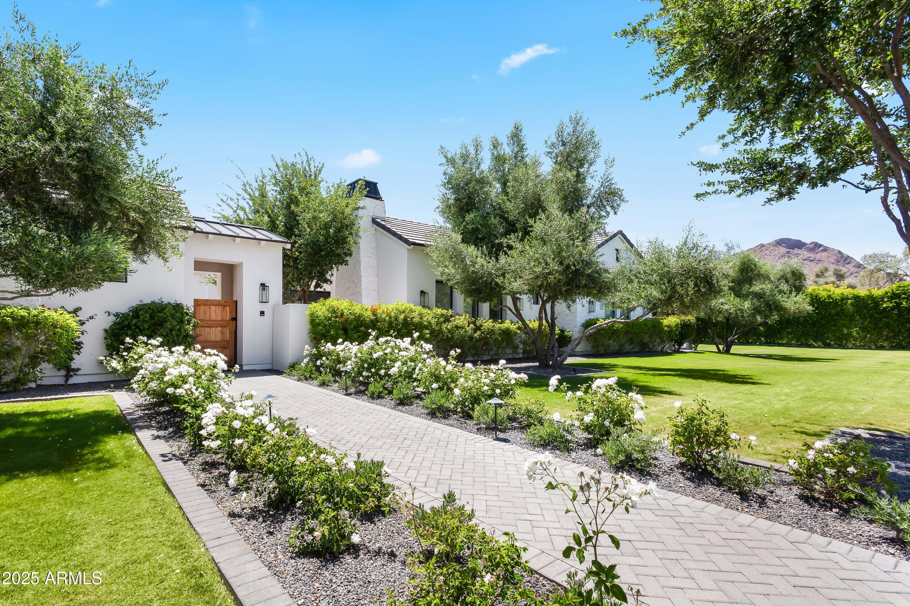 This 2020 Paradise Valley estate blends sleek modern design with sweeping Camelback Mountain views. Set on over an acre, it offers 7,000+ sq/ft of luxury living—featuring a 4-bed, 5-bath main house, a private casita, and a fully equipped pool house. Designed for both comfort and entertaining, it boasts a chef's kitchen with Wolf/Sub-Zero appliances, expansive great room, and seamless indoor-outdoor flow to covered patios, a resort-style pool, spa, and built-in BBQ. The primary suite includes a spa bath, oversized closet, private outdoor shower, and hot tub—perfect for relaxing in style.