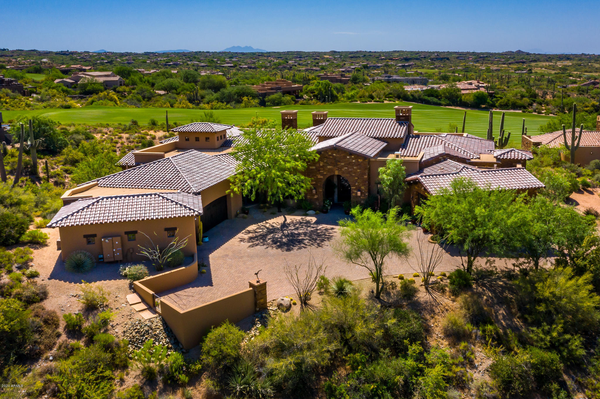 Tuscan estate home on 7th fairway of Desert  Mountain's picturesque Chiricahua course. Panoramic S & SE vistas span from Four Peaks to Pinnacle Peak. No steps, great room plan with electric lanai doors, chef's kitchen, 250 bottle wine room, executive office, split master with double his/her baths plus steam shower, workout room, sunroom  and mega closets. Extensive technology, security camera system, art lighting and Lutron lighting controls. Resort patio with neg edge pool & spa, and generous sun & shade areas for ultimate desert living. Stonework, beamed ceilings and custom cabinetry throughout created by Stonehenge Builder's team of Italian craftsmen.  Private drive, oversized 3-car garage.  Lifestyle and golf club memberships available thru application.