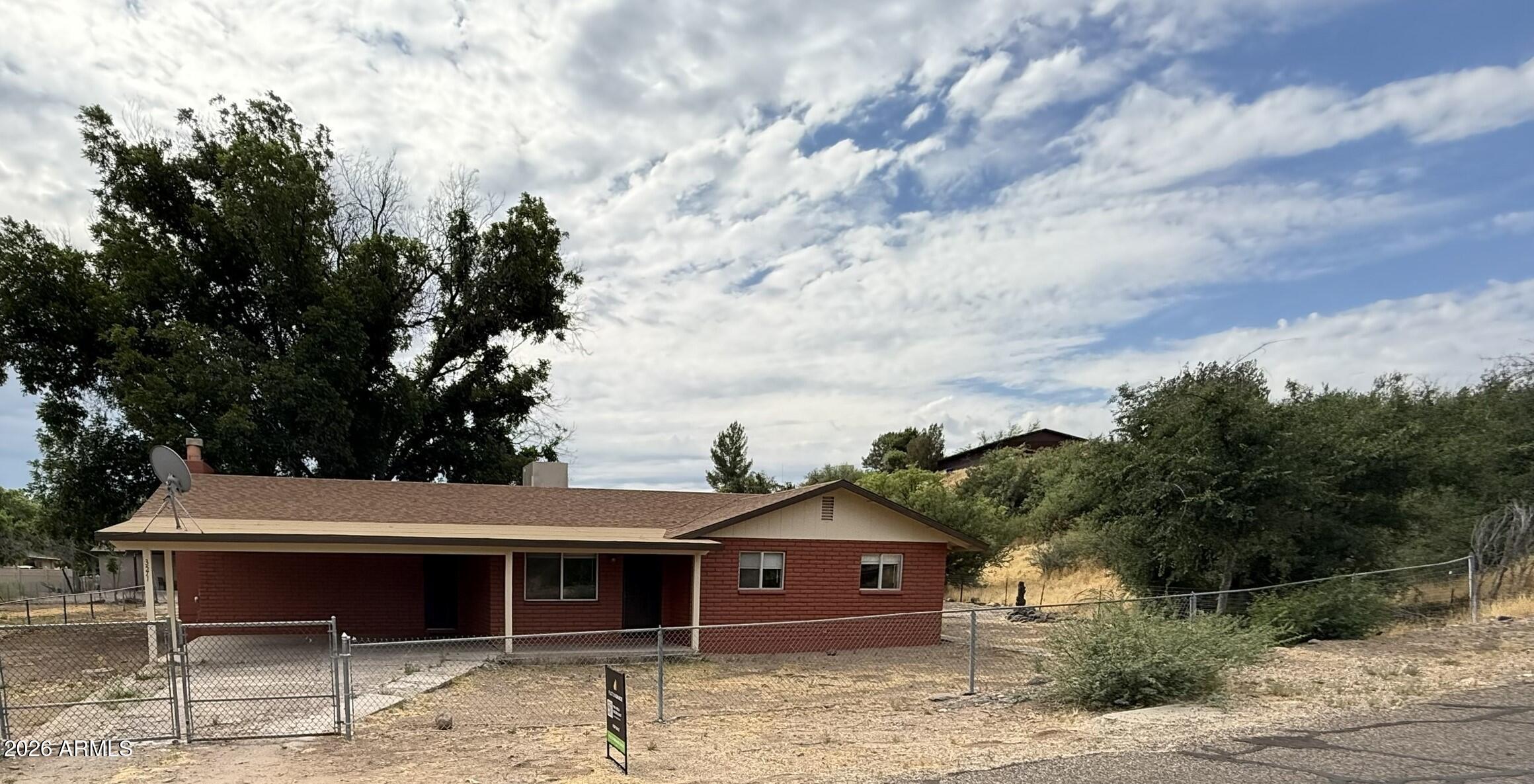 Recently updated home just steps from beautiful Clear Creek without being in the flood zone! Located on a little less than a 1/2 acre in a peaceful quiet neighborhood with amazing mature trees and mountain views. This is a solid built home with an Arizona room and a wood burning fireplace.  Property has a slab with electric, plumbing and gas to add a guest quarter.  Carport can easily be transitioned into a garage.  Great for anyone looking for a second home or a starter home. NO HOA.
